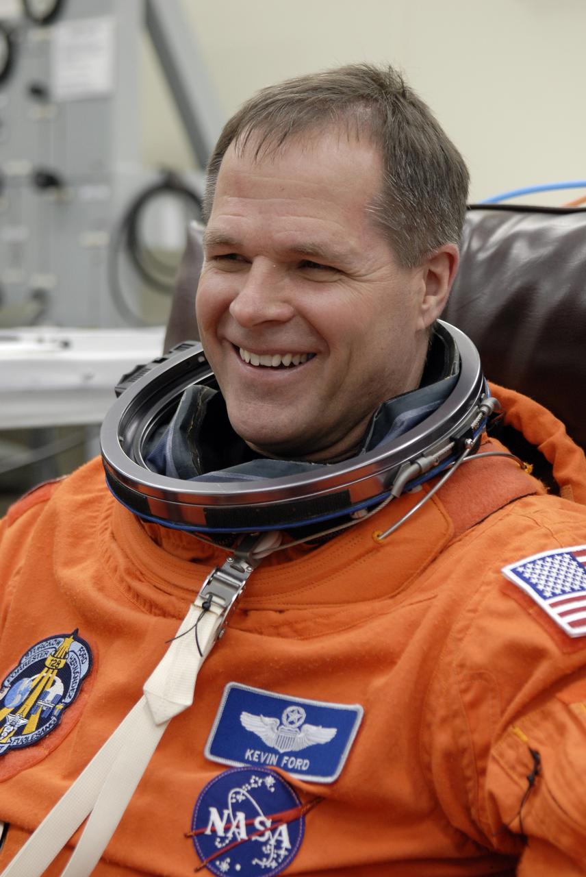 CAPE CANAVERAL, Fla. – STS-128 Pilot Kevin Ford checks the fit of his launch and entry suit before heading to the NASA Kennedy Space Center's Launch Pad 39A for the simulated launch countdown. The countdown is the culmination of terminal countdown demonstration test activities to prepare the STS-128 crew for launch on space shuttle Discovery's STS-128 mission. Discovery will deliver 33,000 pounds of equipment to the station, including science and storage racks, a freezer to store research samples, a new sleeping compartment and the COLBERT treadmill. Launch is targeted for late August. Photo credit: NASA/Kim Shiflett