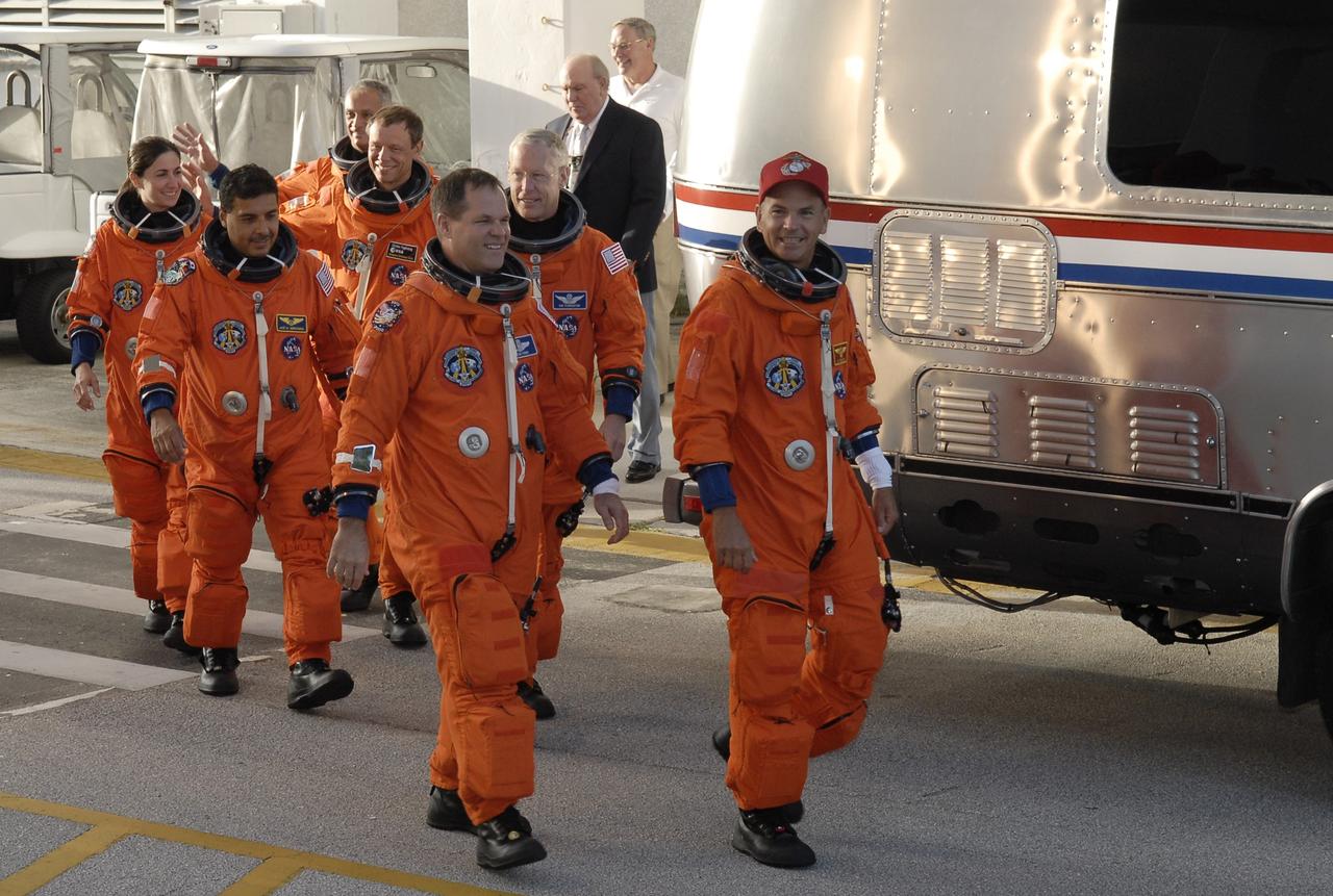 CAPE CANAVERAL, Fla. –  The suited STS-128 crew members head for the Astrovan to take them to NASA Kennedy Space Center's Launch Pad 39A and a simulated launch countdown. From left, in front, are Mission Specialists Nicole Stott and Jose Hernandez and Pilot Kevin Ford.  In back are Mission Specialists Danny Olivas, Christer Fuglesang and Patrick Forrester and Commander Rick Sturckow.  The countdown is the culmination of terminal countdown demonstration test activities to prepare the STS-128 crew for launch on space shuttle Discovery's STS-128 mission. Discovery will deliver 33,000 pounds of equipment to the station, including science and storage racks, a freezer to store research samples, a new sleeping compartment and the COLBERT treadmill.  Launch is targeted for late August. Photo credit: NASA/Kim Shiflett