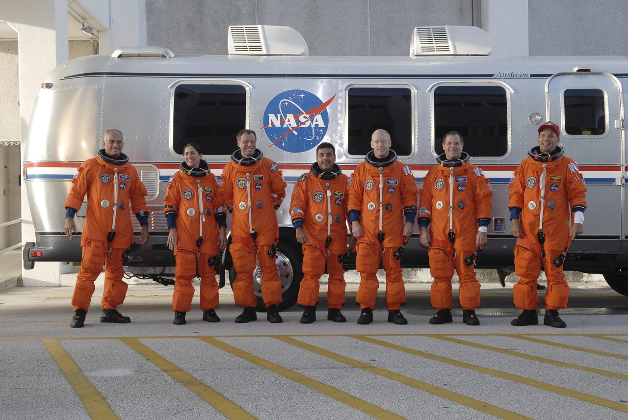 CAPE CANAVERAL, Fla. –  The suited STS-128 crew members pause for a photo in front of the Astrovan before heading to NASA Kennedy Space Center's Launch Pad 39A and a simulated launch countdown.  From left are Mission Specialists Danny Olivas, Nicole Stott, Christer Fuglesang, Jose Hernandez and Patrick Forrester, Pilot Kevin Ford and Commander Rick Sturckow.  The countdown is the culmination of terminal countdown demonstration test activities to prepare the STS-128 crew for launch on space shuttle Discovery's STS-128 mission. Discovery will deliver 33,000 pounds of equipment to the station, including science and storage racks, a freezer to store research samples, a new sleeping compartment and the COLBERT treadmill.  Launch is targeted for late August. Photo credit: NASA/Kim Shiflett