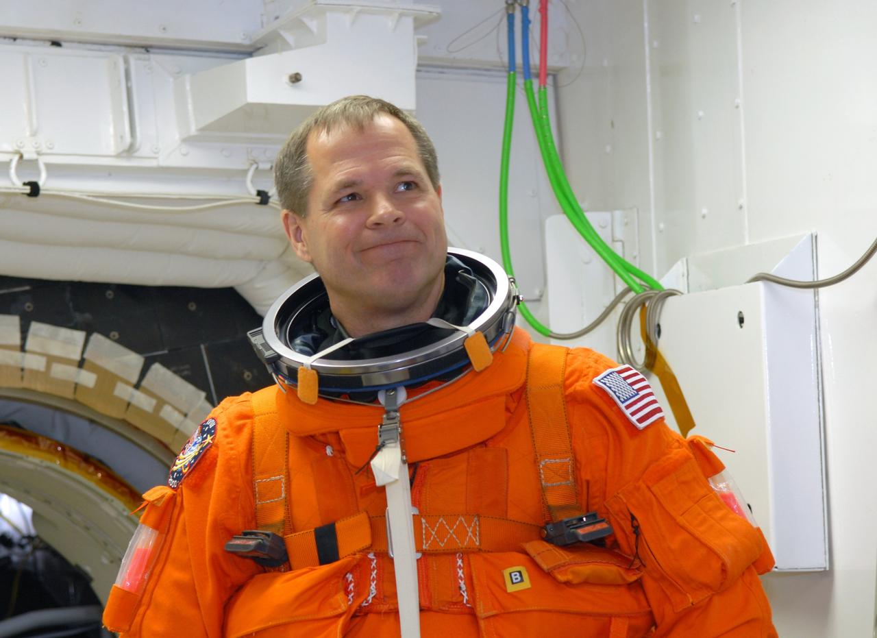 CAPE CANAVERAL, Fla. – STS-128 Pilot Kevin Ford is the White Room on NASA Kennedy Space Center's Launch Pad 39A getting ready to enter space shuttle Discovery. The White Room is at the end of the orbiter access arm and provides entry into the shuttle. Mission crew members are at Kennedy to take part in the terminal countdown demonstration test, or TCDT, which culminates in a simulated launch countdown inside the shuttle. On the STS-128 mission, Discovery will deliver 33,000 pounds of equipment to the station, including science and storage racks, a freezer to store research samples, a new sleeping compartment and the COLBERT treadmill. Launch is targeted for late August. Photo credit: NASA/Jim Grossmann