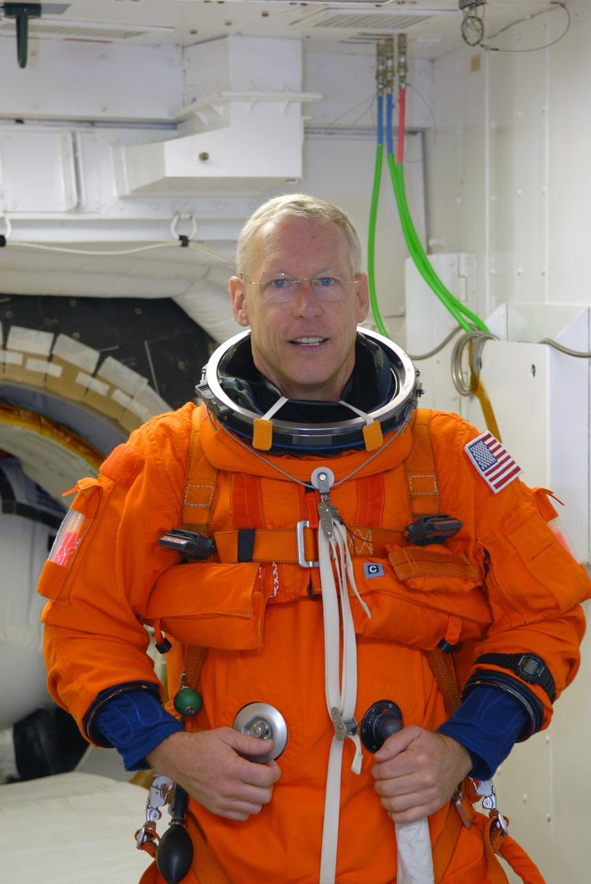 CAPE CANAVERAL, Fla. – STS-128 Mission Specialist Patrick Forrester is the White Room on NASA Kennedy Space Center's Launch Pad 39A getting ready to enter space shuttle Discovery. The White Room is at the end of the orbiter access arm and provides entry into the shuttle. Mission crew members are at Kennedy to take part in the terminal countdown demonstration test, or TCDT, which culminates in a simulated launch countdown inside the shuttle. On the STS-128 mission, Discovery will deliver 33,000 pounds of equipment to the station, including science and storage racks, a freezer to store research samples, a new sleeping compartment and the COLBERT treadmill. Launch is targeted for late August. Photo credit: NASA/Jim Grossmann