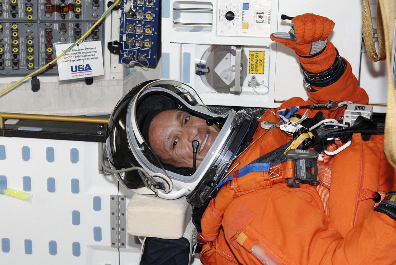CAPE CANAVERAL, Fla. – Seated in space shuttle Discovery's cockpit on NASA Kennedy Space Center's Launch Pad 39A, STS-128 Mission Specialist Danny Olivas is glad to have completed the simulated launch countdown. He and other mission crew members are at Kennedy to take part in the terminal countdown demonstration test, or TCDT, which includes emergency exit training and culminates in the simulated countdown. On the STS-128 mission, Discovery will deliver 33,000 pounds of equipment to the station, including science and storage racks, a freezer to store research samples, a new sleeping compartment and the COLBERT treadmill. Launch is targeted for late August. Photo credit: NASA/Kim Shiflett