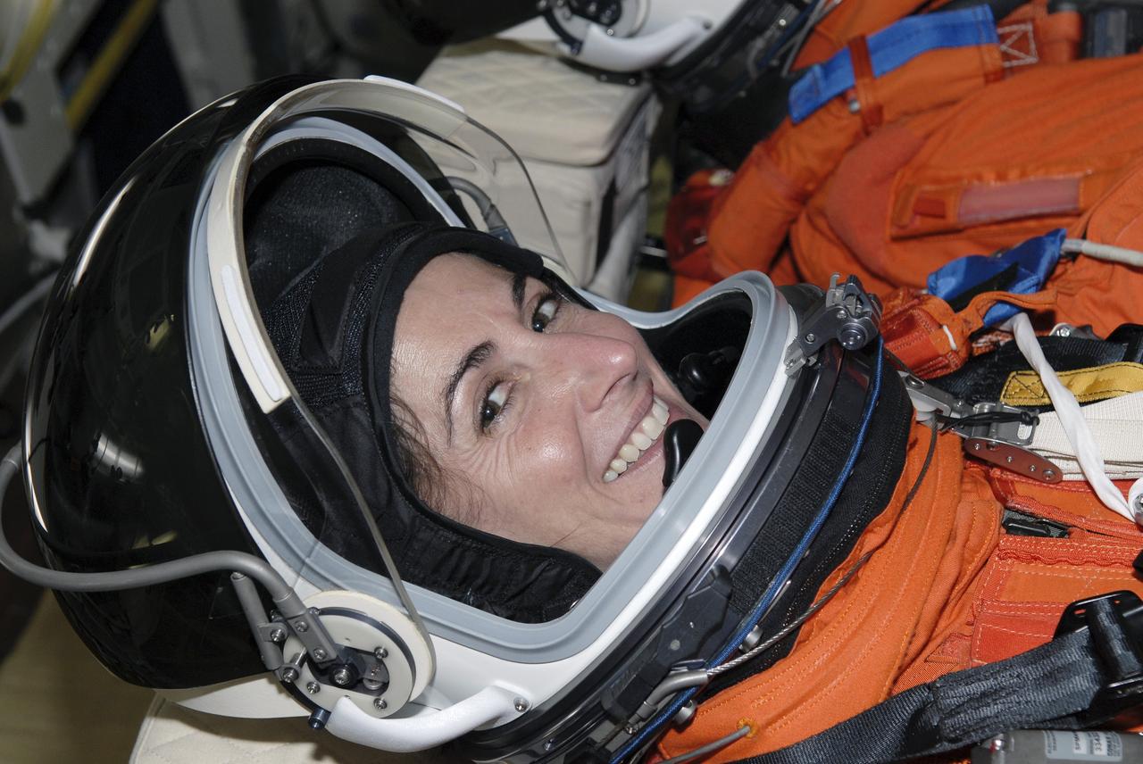 CAPE CANAVERAL, Fla. – Seated in space shuttle Discovery's cockpit on NASA Kennedy Space Center's Launch Pad 39A, STS-128 Mission Specialist Nicole Stott is glad to have completed the simulated launch countdown. She and other mission crew members are at Kennedy to take part in the terminal countdown demonstration test, or TCDT, which includes emergency exit training and culminates in the simulated countdown. On the STS-128 mission, Discovery will deliver 33,000 pounds of equipment to the station, including science and storage racks, a freezer to store research samples, a new sleeping compartment and the COLBERT treadmill. Launch is targeted for late August. Photo credit: NASA/Kim Shiflett