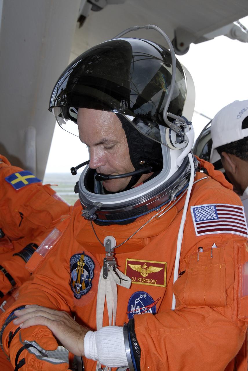 CAPE CANAVERAL, Fla. – After completing emergency exit practice from NASA Kennedy Space Center's fixed service structure, STS-128 Commander Rick Sturckow removes his gloves. Mission crew members are at Kennedy to take part in the terminal countdown demonstration test, or TCDT, which includes emergency exit training and culminates in the simulated countdown. On the STS-128 mission, Discovery will deliver 33,000 pounds of equipment to the station, including science and storage racks, a freezer to store research samples, a new sleeping compartment and the COLBERT treadmill. Launch is targeted for late August. Photo credit: NASA/Kim Shiflett