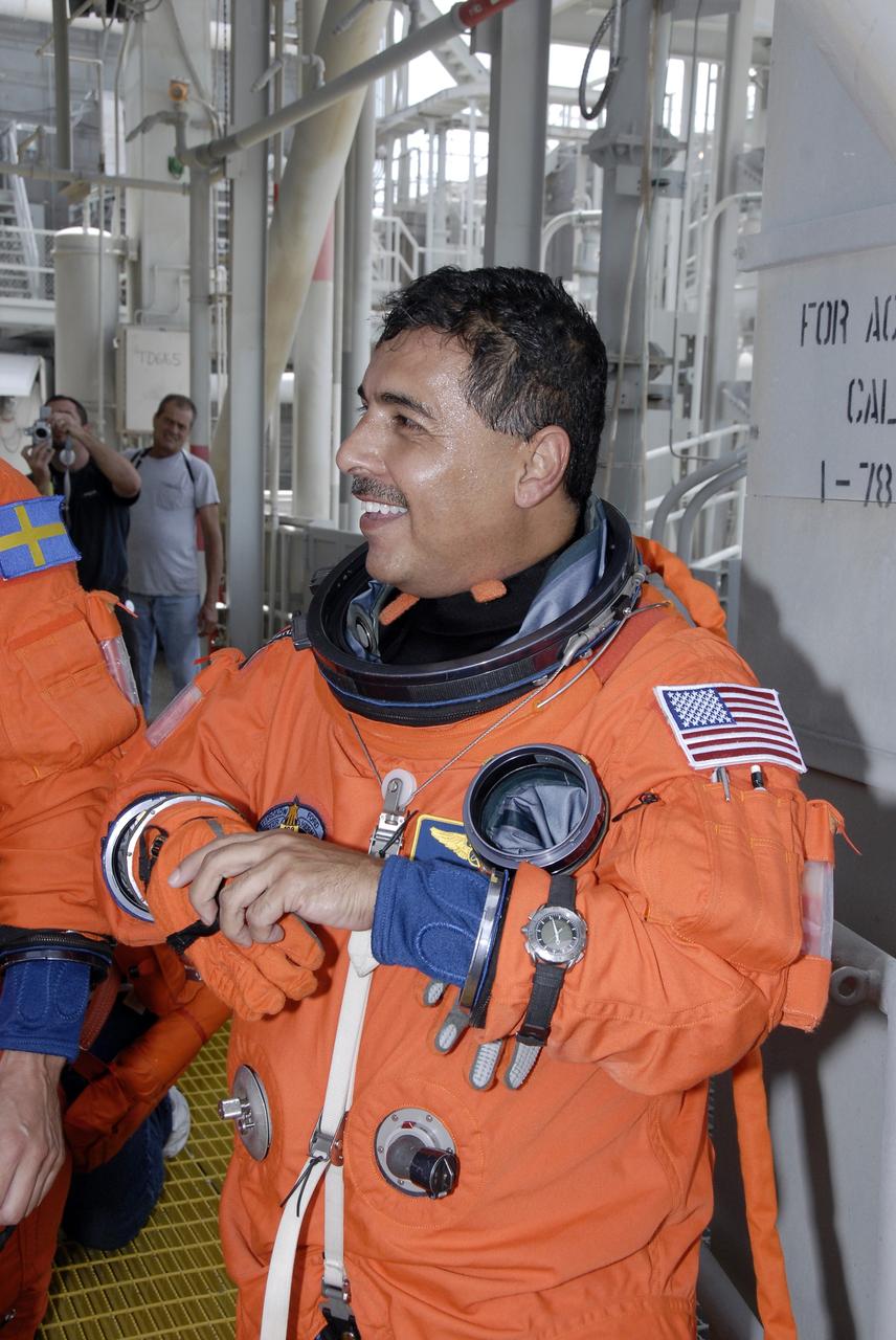 CAPE CANAVERAL, Fla. – After completing emergency exit practice from NASA Kennedy Space Center's fixed service structure, STS-128 Mission Specialist Jose Hernandez removes his gloves. Mission crew members are at Kennedy to take part in the terminal countdown demonstration test, or TCDT, which includes emergency exit training and culminates in the simulated countdown. On the STS-128 mission, Discovery will deliver 33,000 pounds of equipment to the station, including science and storage racks, a freezer to store research samples, a new sleeping compartment and the COLBERT treadmill.  Launch is targeted for late August.   Photo credit: NASA/Kim Shiflett