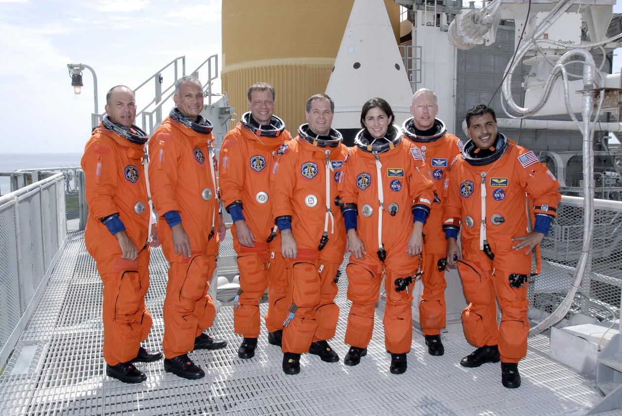 CAPE CANAVERAL, Fla. – The STS-128 crew members gather on the 225-foot level of NASA Kennedy Space Center's fixed service structure.  From left are Commander Rick Sturckow, Mission Specialists Danny Olivas and Christer Fuglesang, Pilot Kevin Ford and Mission Specialists Nicole Stott, Patrick Forrester and Jose Hernandez.  Mission crew members are at Kennedy to take part in the terminal countdown demonstration test, or TCDT, which includes emergency exit training and culminates in the simulated countdown. On the STS-128 mission, Discovery will deliver 33,000 pounds of equipment to the station, including science and storage racks, a freezer to store research samples, a new sleeping compartment and the COLBERT treadmill.  Launch is targeted for late August.   Photo credit: NASA/Kim Shiflett
