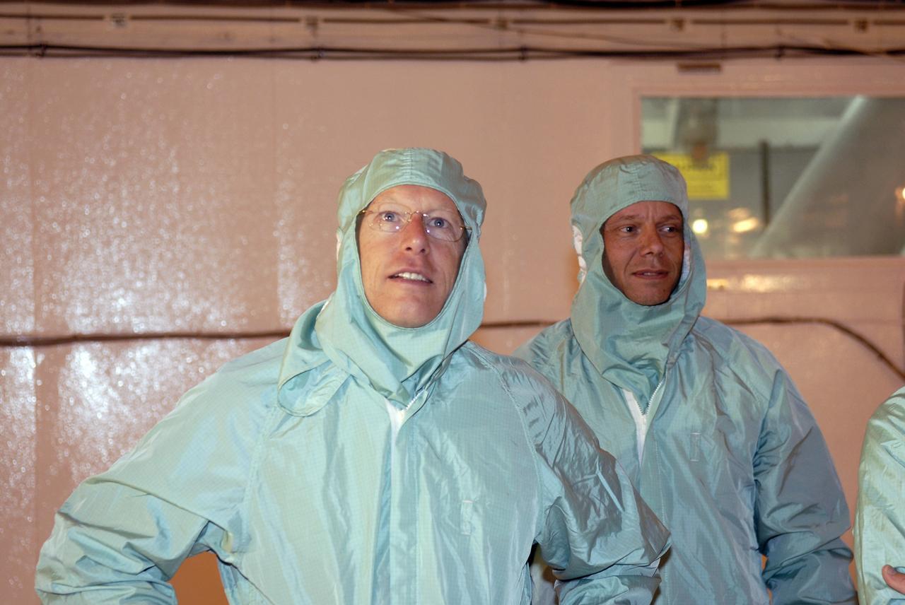 CAPE CANAVERAL, Fla. – In the Payload Changeout Room on NASA Kennedy Space Center's Launch Pad 39A, STS-128 Mission Specialists Patrick Forrester (left) and Christer Fuglesang take a close look at the payloads to be installed in space shuttle Discovery. The crew is at Kennedy to take part in the terminal countdown demonstration test, or TCDT, which includes equipment familiarization, emergency exit training and a simulated countdown. On the STS-128 mission, Discovery will deliver 33,000 pounds of equipment to the station, including science and storage racks, a freezer to store research samples, a new sleeping compartment and the COLBERT treadmill. Launch is targeted for late August. Photo credit: NASA/Kim Shiflett