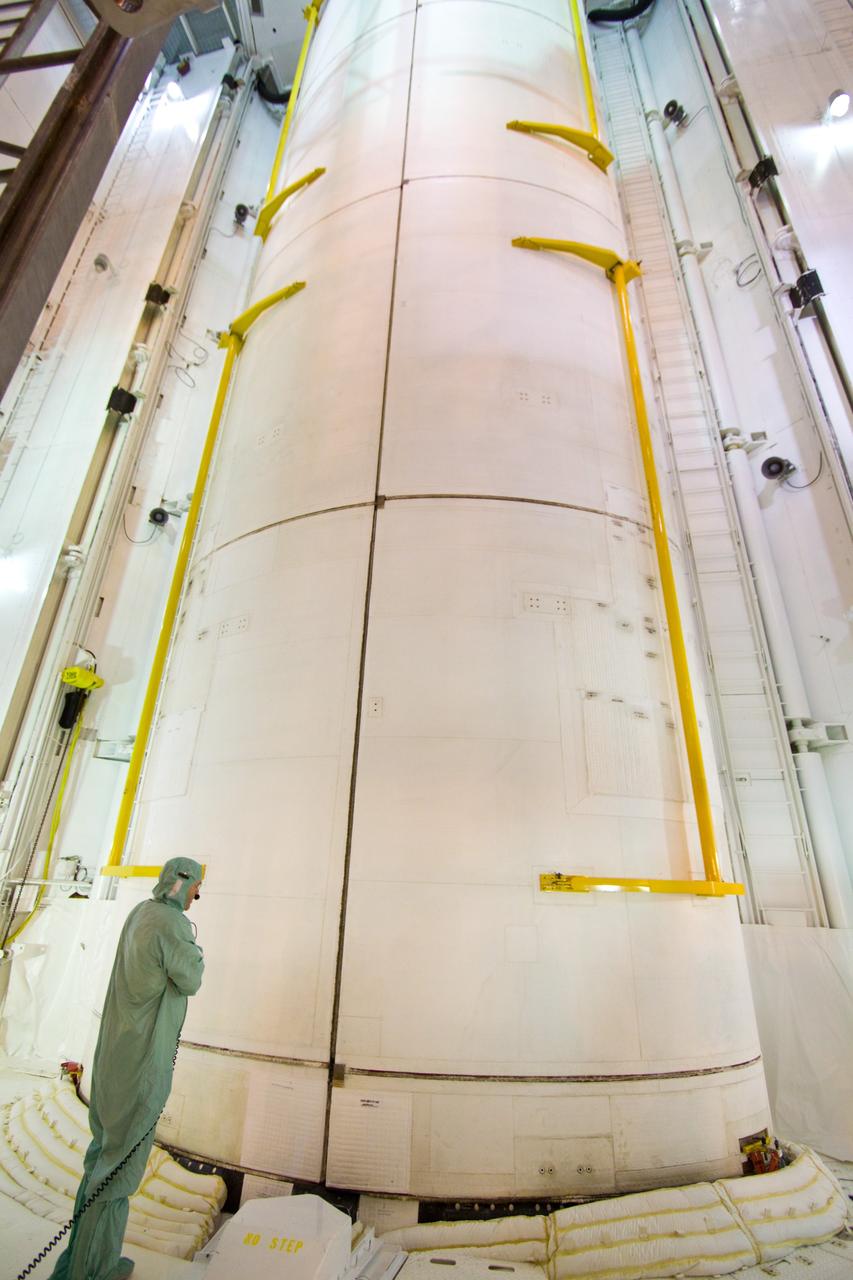 CAPE CANAVERAL, Fla. – On Launch Pad 39A, a technician checks the closing of the payload bay door around the multi-purpose logistics module Leonardo and the lightweight multi-purpose experiment support structure carrier inside space shuttle Discovery's payload bay. Discovery will deliver 33,000 pounds of equipment to the station, including science and storage racks, a freezer to store research samples, a new sleeping compartment and the COLBERT treadmill. Launch is targeted for late August. Photo credit: NASA/Jack Pfaller