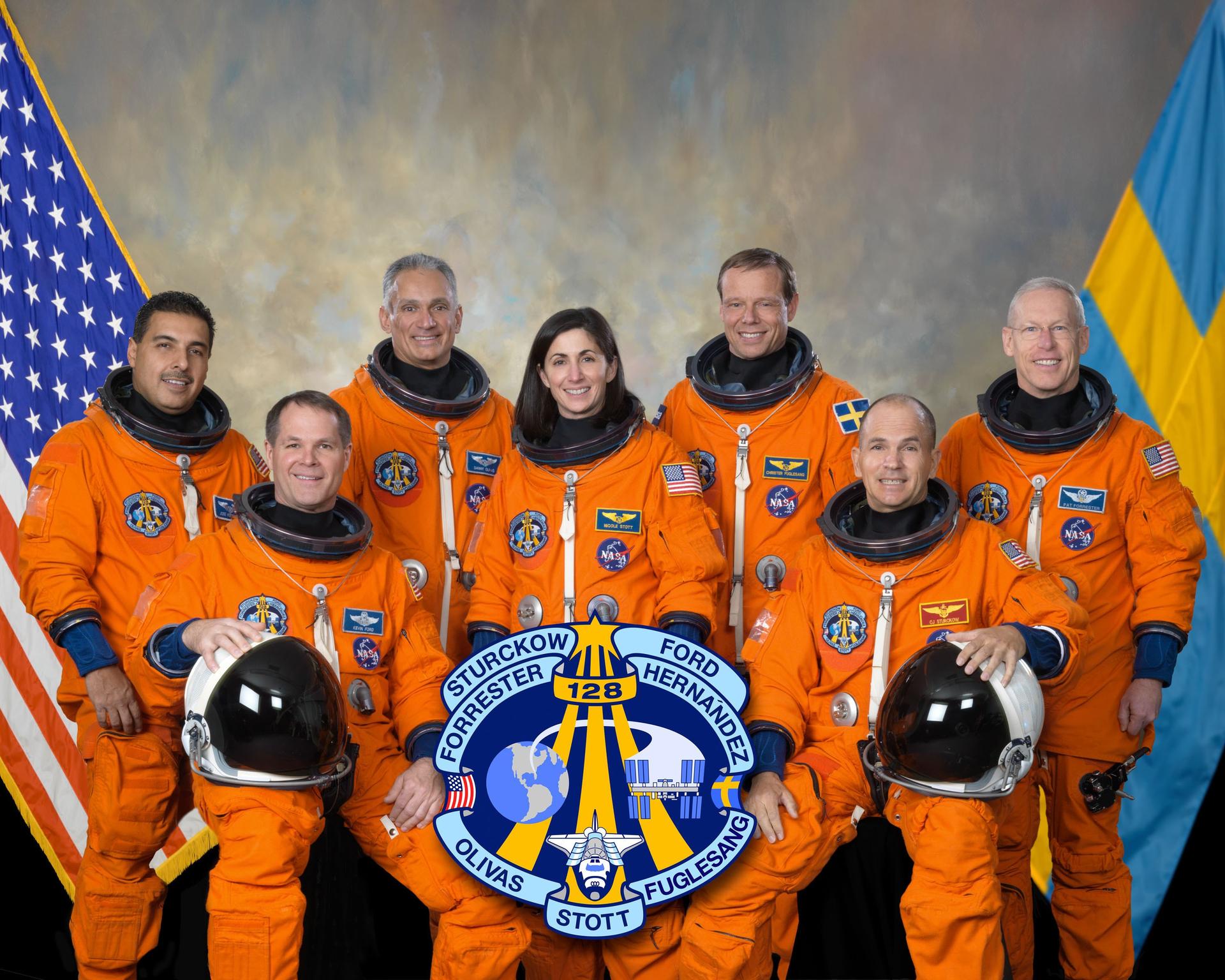 Attired in training versions of their shuttle launch and entry suits, these seven astronauts take a break from training to pose for the STS-128 crew portrait.