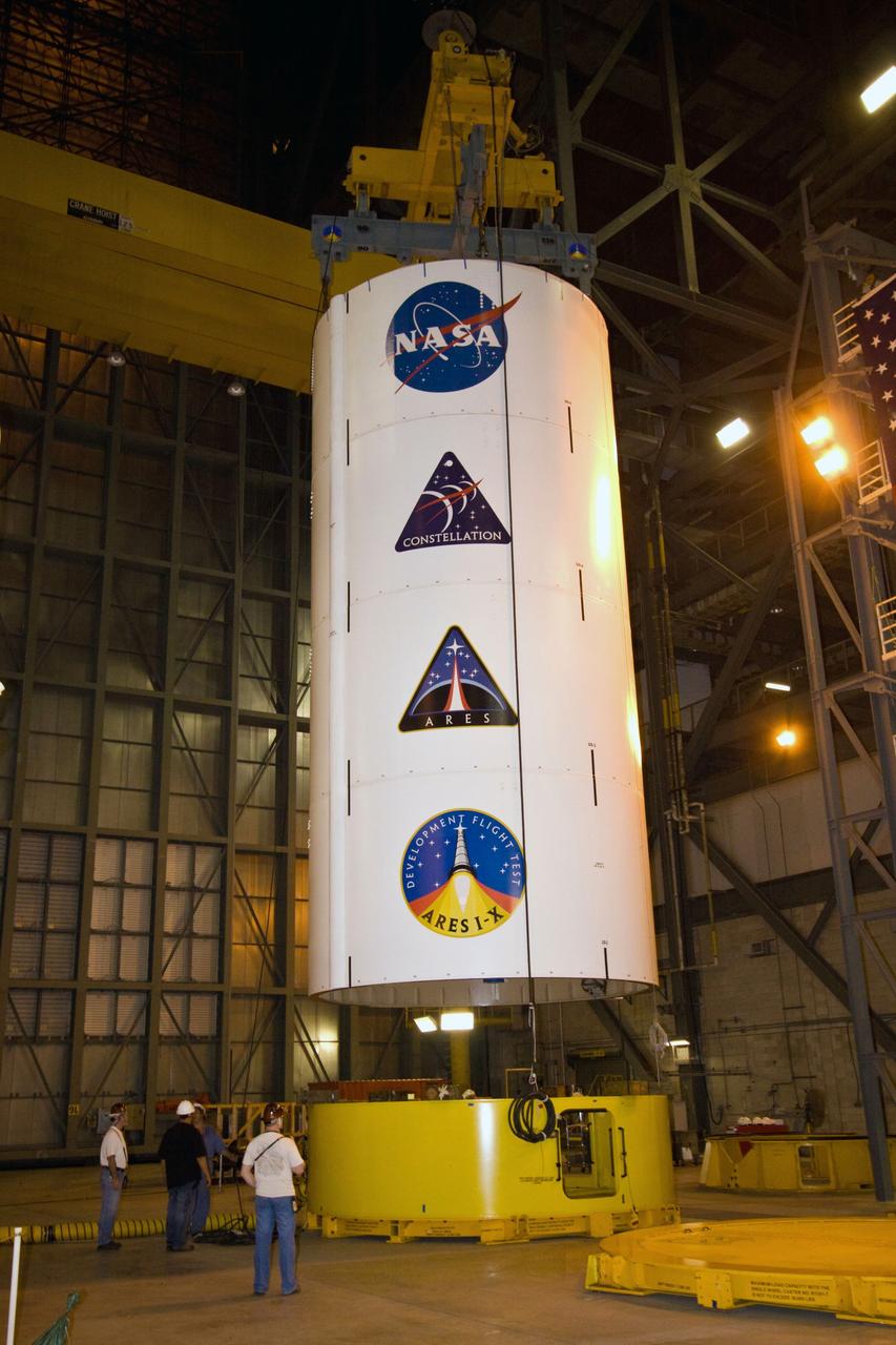 CAPE CANAVERAL, Fla. – In NASA Kennedy Space Center's Vehicle Assembly Building High Bay 3, a crane lifts the Ares I-X Super Stack 3 from its stand. The stack is being moved across the transfer aisle to High Bay 4 for integration with Super Stack 2. The upper stage comprises five super stacks, which are integrated with the four-segment solid rocket booster first stage on the mobile launch platform. Ares I-X is the test vehicle for the Ares I, which is part of the Constellation Program to return men to the moon and beyond. The Ares I-X flight test is targeted for Oct. 31, pending formal NASA Headquarters approval. Photo credit: NASA/Jack Pfaller