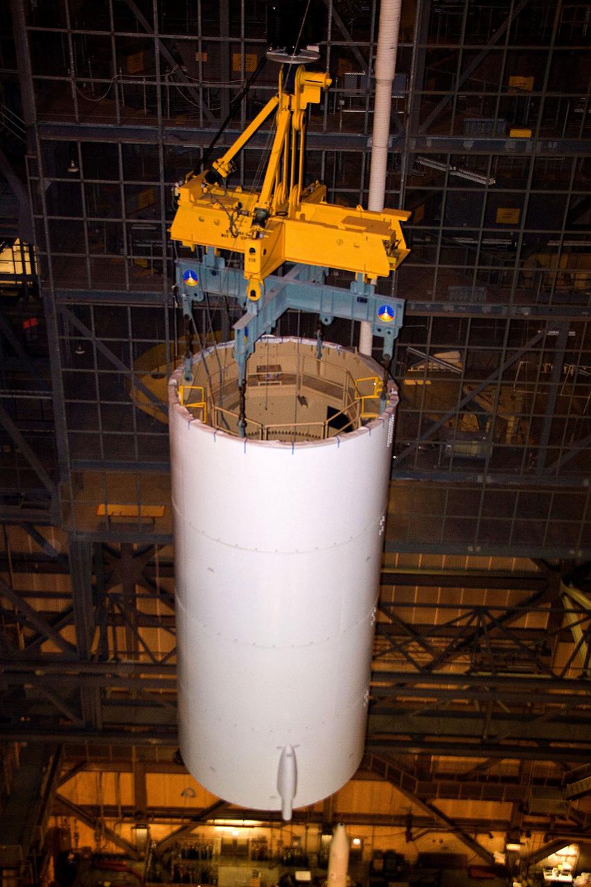 CAPE CANAVERAL, Fla. – In NASA Kennedy Space Center's Vehicle Assembly Building High Bay 3, a crane moves the Ares I-X Super Stack 3 across the transfer aisle to High Bay 4. There it will be integrated with Super Stack 2. The upper stage comprises five super stacks, which are integrated with the four-segment solid rocket booster first stage on the mobile launch platform. Ares I-X is the test vehicle for the Ares I, which is part of the Constellation Program to return men to the moon and beyond. The Ares I-X flight test is targeted for Oct. 31, pending formal NASA Headquarters approval. Photo credit: NASA/Jack Pfaller