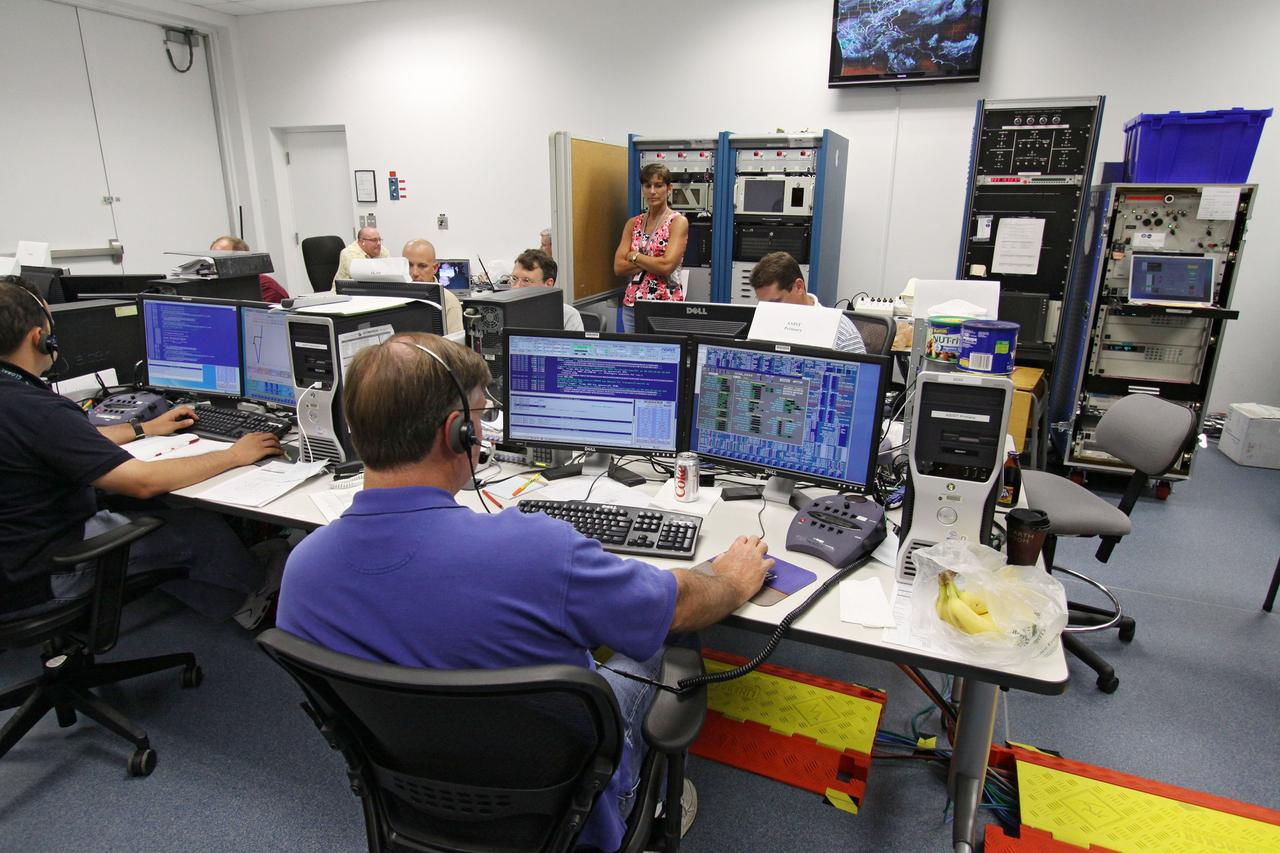 CAPE CANAVERAL, Fla. – At the Astrotech Space Operations facility in Titusville, Fla., workers in the control room monitor the data on computer screens from the movement of the high-gain antenna on the Solar Dynamics Observatory, or SDO.  The SDO is undergoing performance testing.  All of the spacecraft science instruments are being tested in their last major evaluation before launch.  SDO is the first space weather research network mission in NASA's Living With a Star Program.  The spacecraft's long-term measurements will give solar scientists in-depth information about changes in the sun's magnetic field and insight into how they affect Earth.  In preparation for launch, engineers will perform a battery of comprehensive tests to ensure SDO can withstand the stresses and vibrations of the launch itself, as well as what it will encounter in the space environment after launch.  Liftoff on an Atlas V rocket is scheduled for Dec. 4.  Photo credit: NASA/Jack Pfaller