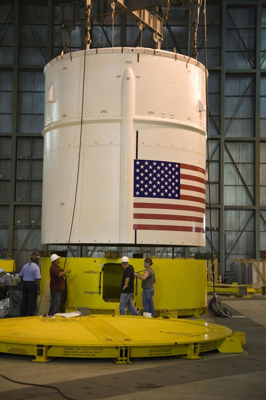 CAPE CANAVERAL, Fla. – In the Vehicle Assembly Building's High Bay 4 at NASA's Kennedy Space Center in Florida, a crane lifts the Ares I-X Super Stack 4.  The stack will be moved to High Bay 3 for integration with Super Stack 3.  Five super stacks make up the upper stage that will be integrated with the four-segment solid rocket booster first stage on the mobile launch platform.  Ares I-X is the test vehicle for the Ares I, which is part of the Constellation Program to return men to the moon and beyond. The Ares I-X flight test is targeted for  Oct. 31, pending formal NASA Headquarters approval. Photo credit: NASA/Dimitri Gerondidakis