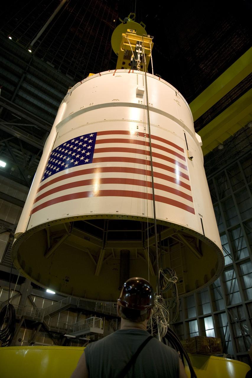 CAPE CANAVERAL, Fla. – In the Vehicle Assembly Building's High Bay 4 at NASA's Kennedy Space Center in Florida, a crane lifts the Ares I-X Super Stack 4.  The stack will be moved to High Bay 3 for integration with Super Stack 3.  Five super stacks make up the upper stage that will be integrated with the four-segment solid rocket booster first stage on the mobile launch platform.  Ares I-X is the test vehicle for the Ares I, which is part of the Constellation Program to return men to the moon and beyond. The Ares I-X flight test is targeted for  Oct. 31, pending formal NASA Headquarters approval. Photo credit: NASA/Dimitri Gerondidakis