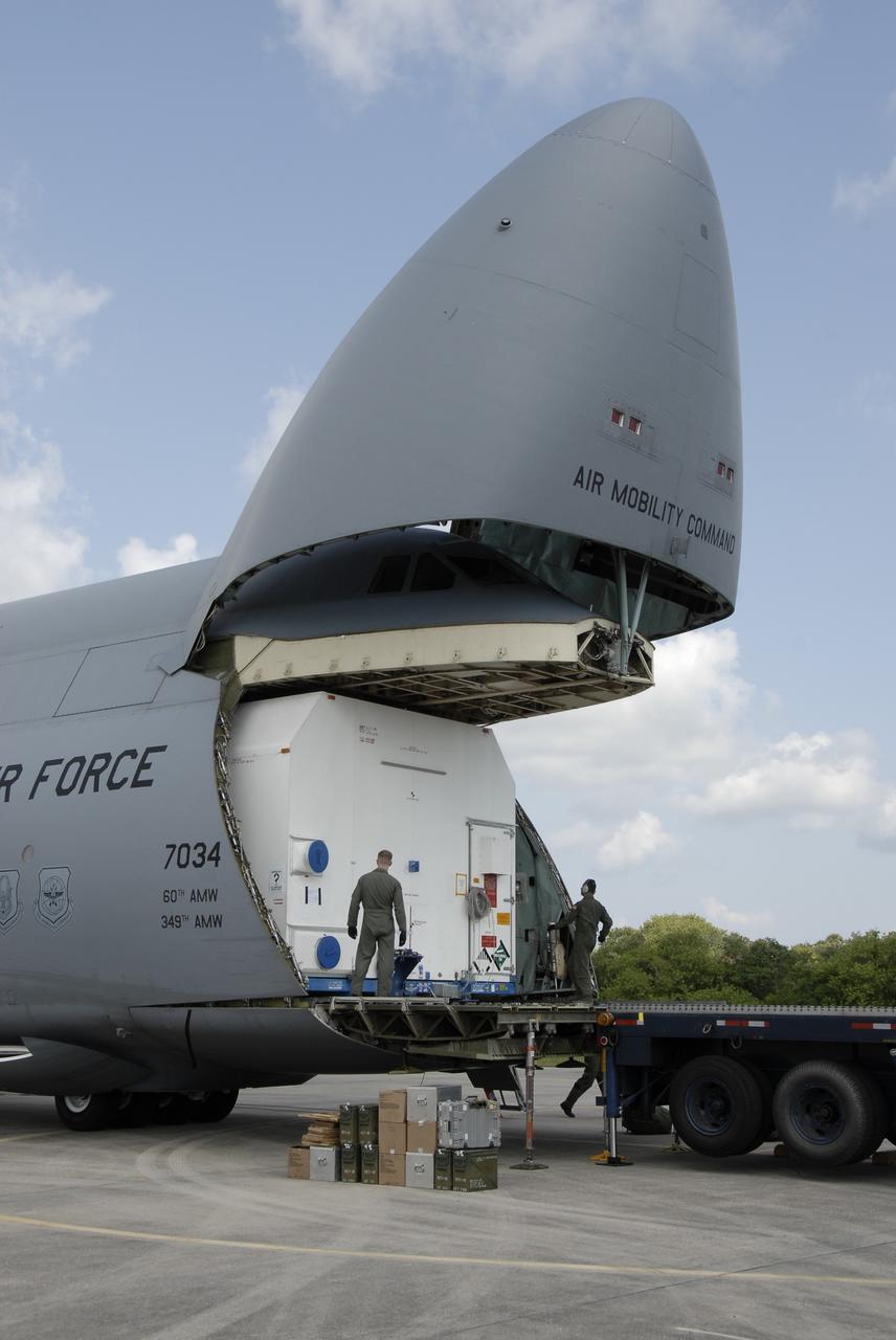 CAPE CANAVERAL, Fla. – At NASA Kennedy Space Center's Shuttle Landing Facility, the SV-1 cargo of the STSS Demonstrator spacecraft moves out of the U.S. Air Force C-17. The cargo will be transferred to the Astrotech payload processing facility in Titusville, Fla. The spacecraft is a midcourse tracking technology demonstrator, part of an evolving ballistic missile defense system. STSS is capable of tracking objects after boost phase and provides trajectory information to other sensors. It will be launched by NASA for the Missile Defense Agency in late summer.  Photo credit: NASA/Kim Shiflett  (Approved for Public Release 09-MDA-4804 [4 Aug 09] )