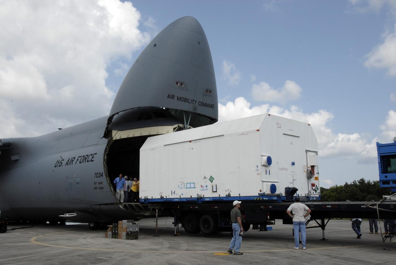 CAPE CANAVERAL, Fla. – At NASA Kennedy Space Center's Shuttle Landing Facility, the SV-1 cargo of the STSS Demonstrator spacecraft moves out of the U.S. Air Force C-17. The cargo will be transferred to the Astrotech payload processing facility in Titusville, Fla.   The spacecraft is a midcourse tracking technology demonstrator, part of an evolving ballistic missile defense system. STSS is capable of tracking objects after boost phase and provides trajectory information to other sensors. It will be launched by NASA for the Missile Defense Agency in late summer.  Photo credit: NASA/Kim Shiflett  (Approved for Public Release 09-MDA-4804 [4 Aug 09] )
