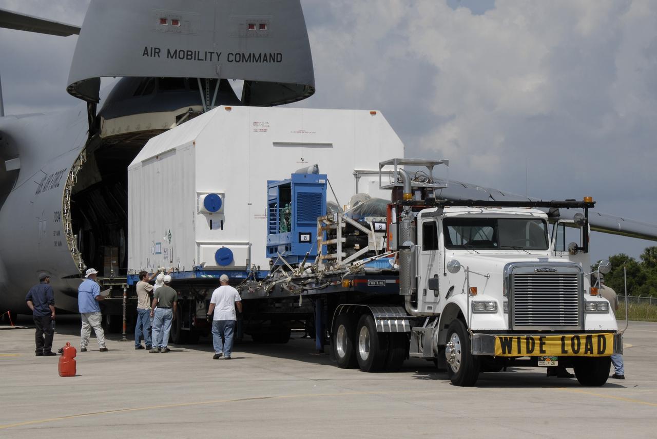 CAPE CANAVERAL, Fla. – At NASA Kennedy Space Center's Shuttle Landing Facility, the SV-1 cargo of the STSS Demonstrator spacecraft is moved onto a flatbed truck for transfer to the Astrotech payload processing facility in Titusville, Fla.  The spacecraft is a midcourse tracking technology demonstrator, part of an evolving ballistic missile defense system. STSS is capable of tracking objects after boost phase and provides trajectory information to other sensors. It will be launched by NASA for the Missile Defense Agency in late summer.  Photo credit: NASA/Kim Shiflett  (Approved for Public Release 09-MDA-4804 [4 Aug 09] )