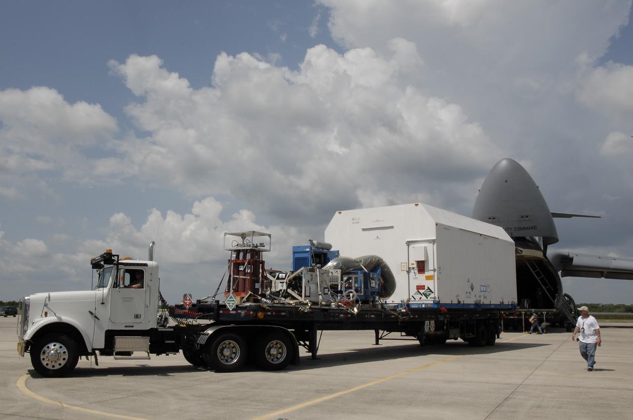 CAPE CANAVERAL, Fla. – At NASA Kennedy Space Center's Shuttle Landing Facility, the flatbed truck  with the SV-1 cargo of the STSS Demonstrator spacecraft begins moving to the Astrotech payload processing facility in Titusville, Fla.  The spacecraft is a midcourse tracking technology demonstrator, part of an evolving ballistic missile defense system. STSS is capable of tracking objects after boost phase and provides trajectory information to other sensors. It will be launched by NASA for the Missile Defense Agency in late summer.  Photo credit: NASA/Kim Shiflett  (Approved for Public Release 09-MDA-4804 [4 Aug 09] )