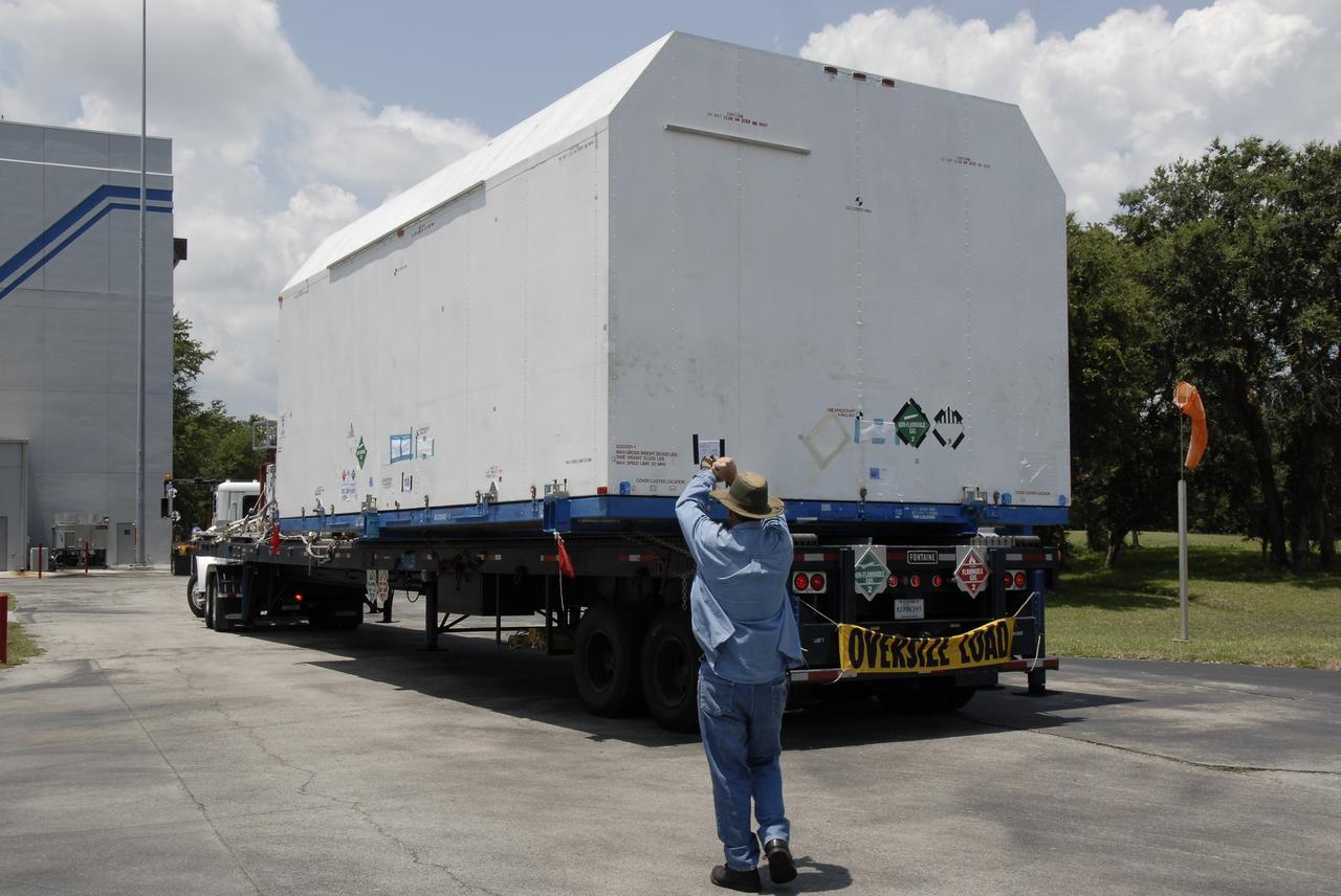 CAPE CANAVERAL, Fla. – The flatbed truck  with the SV-1 cargo of the STSS Demonstrator spacecraft arrives at the Astrotech payload processing facility in Titusville, Fla. The spacecraft is a midcourse tracking technology demonstrator, part of an evolving ballistic missile defense system. STSS is capable of tracking objects after boost phase and provides trajectory information to other sensors. It will be launched by NASA for the Missile Defense Agency in late summer.  Photo credit: NASA/Kim Shiflett  (Approved for Public Release 09-MDA-4804 [4 Aug 09] )