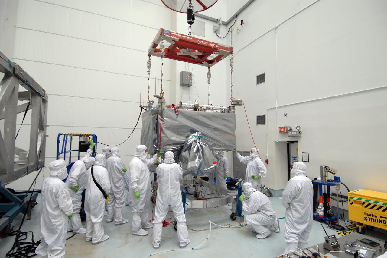 CAPE CANAVERAL, Fla. – In the Astrotech payload processing facility in Titusville, Fla. , the  STSS Demonstrator SV-1 spacecraft is lowered onto a stand. The spacecraft is a midcourse tracking technology demonstrator, part of an evolving ballistic missile defense system. STSS is capable of tracking objects after boost phase and provides trajectory information to other sensors. It will be launched by NASA for the Missile Defense Agency in late summer.  Photo credit: NASA/Tim Jacobs  (Approved for Public Release 09-MDA-4800 [30 July 09] )