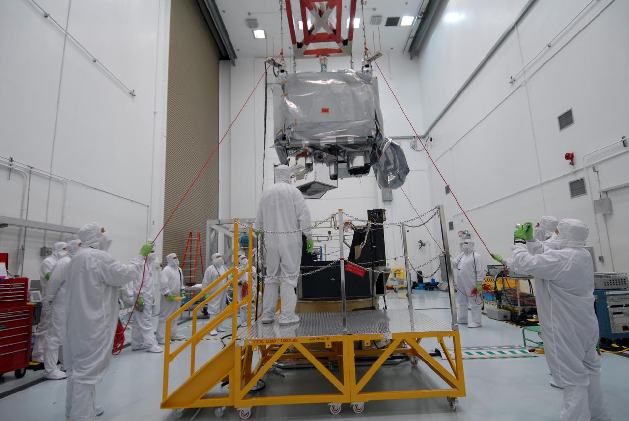 CAPE CANAVERAL, Fla. – In the Astrotech payload processing facility in Titusville, Fla. , the  STSS Demonstrator SV-1 spacecraft is lowered toward the orbital insertion system. The spacecraft is a midcourse tracking technology demonstrator, part of an evolving ballistic missile defense system. STSS is capable of tracking objects after boost phase and provides trajectory information to other sensors. It will be launched by NASA for the Missile Defense Agency in late summer.  Photo credit: NASA/Tim Jacobs  (Approved for Public Release 09-MDA-4800 [30 July 09] )