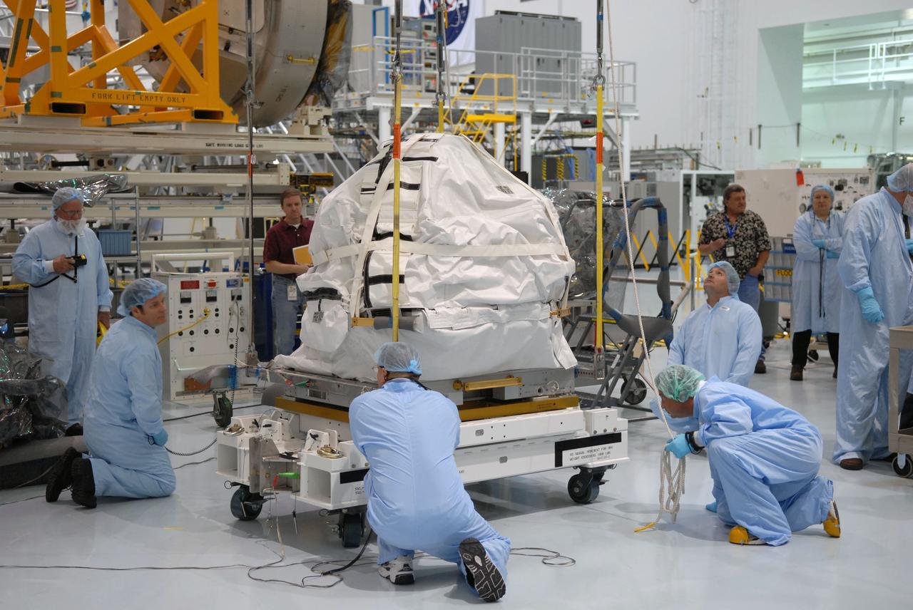 CAPE CANAVERAL, Fla. – In the Space Station Processing Facility at NASA's Kennedy Space Center in Florida, technicians monitor a control moment gyroscope as it is lifted by crane from a work stand. The gyroscope will be installed on an EXPRESS Logistics Carrier for flight.  The carrier is part of the STS-129 payload on space shuttle Atlantis, which will deliver to the International Space Station two spare gyroscopes, two nitrogen tank assemblies, two pump modules, an ammonia tank assembly and a spare latching end effector for the station's robotic arm. STS-129 is targeted to launch Nov. 12. Photo credit: NASA/Jim Grossmann