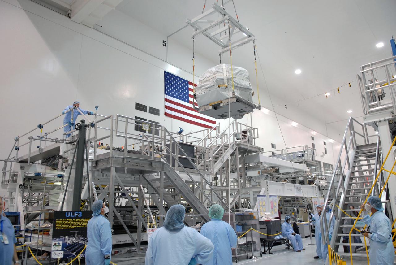CAPE CANAVERAL, Fla. – In the Space Station Processing Facility at NASA's Kennedy Space Center in Florida, a control moment gyroscope is lifted by crane toward an EXPRESS Logistics Carrier on which it will be installed for flight.  The carrier is part of the STS-129 payload on space shuttle Atlantis, which will deliver to the International Space Station two spare gyroscopes, two nitrogen tank assemblies, two pump modules, an ammonia tank assembly and a spare latching end effector for the station's robotic arm. STS-129 is targeted to launch Nov. 12. Photo credit: NASA/Jim Grossmann
