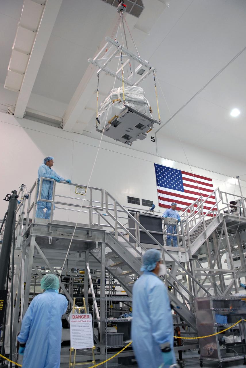 CAPE CANAVERAL, Fla. – In the Space Station Processing Facility at NASA's Kennedy Space Center in Florida, a control moment gyroscope is lifted by crane above an EXPRESS Logistics Carrier on which it will be installed for flight.  The carrier is part of the STS-129 payload on space shuttle Atlantis, which will deliver to the International Space Station two spare gyroscopes, two nitrogen tank assemblies, two pump modules, an ammonia tank assembly and a spare latching end effector for the station's robotic arm. STS-129 is targeted to launch Nov. 12. Photo credit: NASA/Jim Grossmann