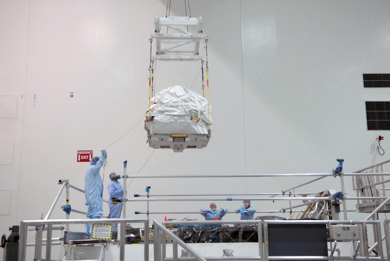 CAPE CANAVERAL, Fla. – In the Space Station Processing Facility at NASA's Kennedy Space Center in Florida, a control moment gyroscope is lowered by crane onto an EXPRESS Logistics Carrier on which it will be installed for flight.  The carrier is part of the STS-129 payload on space shuttle Atlantis, which will deliver to the International Space Station two spare gyroscopes, two nitrogen tank assemblies, two pump modules, an ammonia tank assembly and a spare latching end effector for the station's robotic arm. STS-129 is targeted to launch Nov. 12. Photo credit: NASA/Jim Grossmann