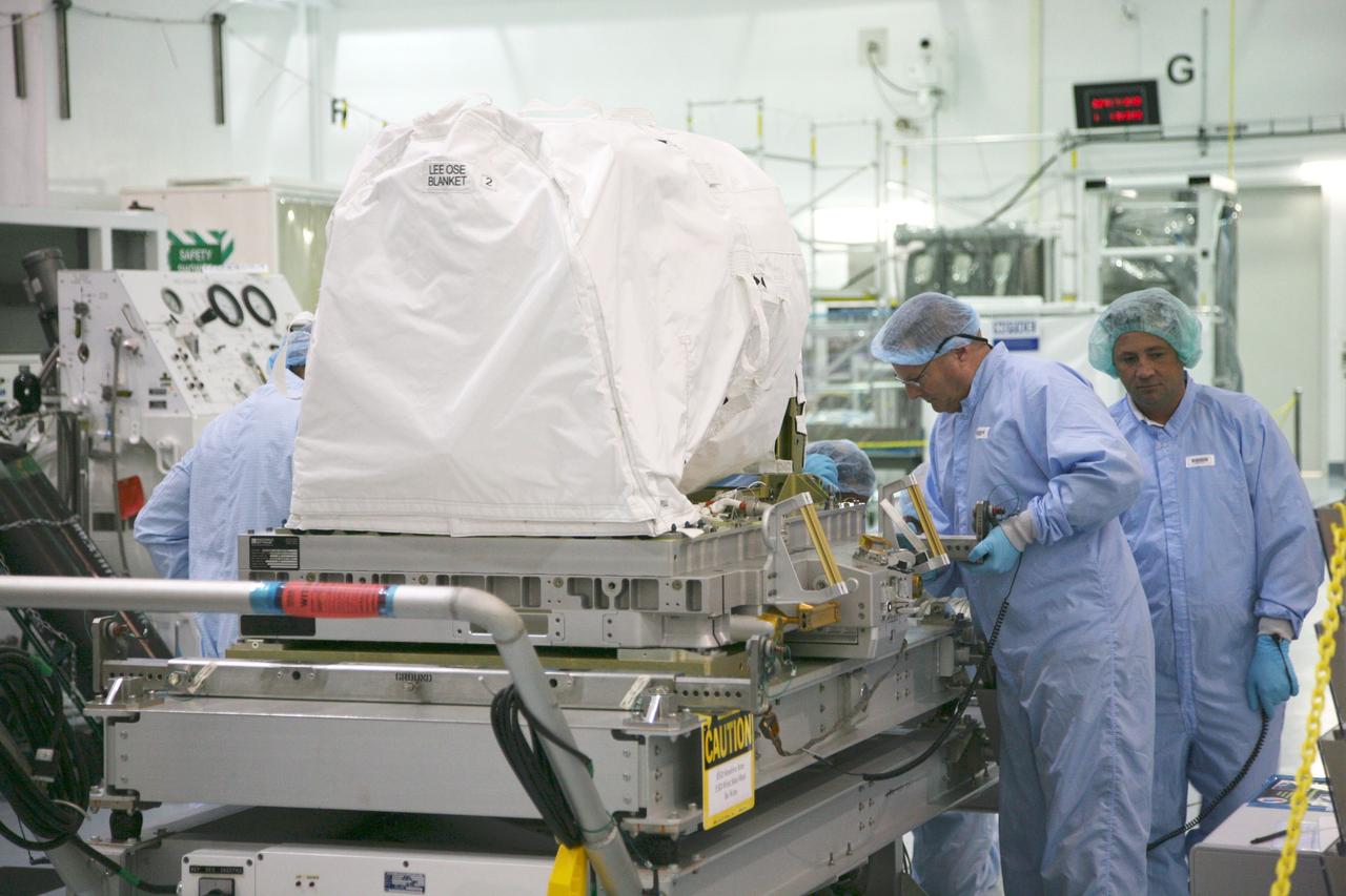 CAPE CANAVERAL, Fla. – In the Space Station Processing Facility at NASA's Kennedy Space Center in Florida, technicians prepare for a latching end effector to be lifted from a work stand. The effector will be installed on an EXPRESS Logistics Carrier for flight.  The carrier is part of the STS-129 payload on space shuttle Atlantis, which will deliver to the International Space Station two spare gyroscopes, two nitrogen tank assemblies, two pump modules, an ammonia tank assembly and a spare latching end effector for the station's robotic arm. STS-129 is targeted to launch Nov. 12. Photo credit: NASA/Dimitri Gerondidakis