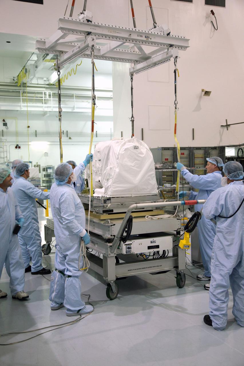 CAPE CANAVERAL, Fla. – In the Space Station Processing Facility at NASA's Kennedy Space Center in Florida, technicians prepare for a latching end effector to be lifted by crane from a work stand. The effector will be installed on an EXPRESS Logistics Carrier for flight.  The carrier is part of the STS-129 payload on space shuttle Atlantis, which will deliver to the International Space Station two spare gyroscopes, two nitrogen tank assemblies, two pump modules, an ammonia tank assembly and a spare latching end effector for the station's robotic arm. STS-129 is targeted to launch Nov. 12. Photo credit: NASA/Dimitri Gerondidakis
