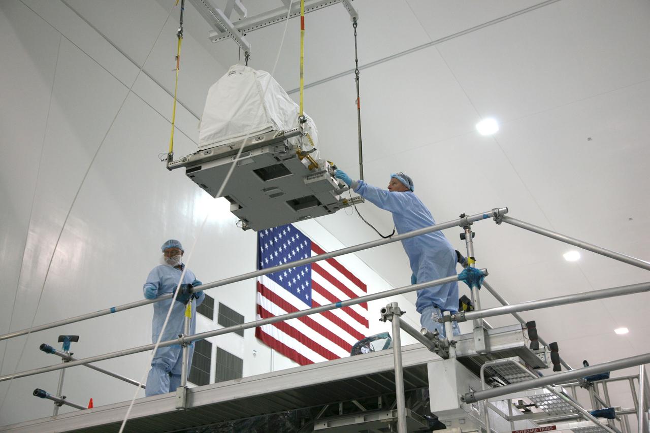 CAPE CANAVERAL, Fla. – In the Space Station Processing Facility at NASA's Kennedy Space Center in Florida, a technician guides a latching end effector as it is lowered by crane toward an EXPRESS Logistics Carrier on which it will be installed for flight. The carrier is part of the STS-129 payload on space shuttle Atlantis, which will deliver to the International Space Station two spare gyroscopes, two nitrogen tank assemblies, two pump modules, an ammonia tank assembly and a spare latching end effector for the station's robotic arm. STS-129 is targeted to launch Nov. 12. Photo credit: NASA/Dimitri Gerondidakis