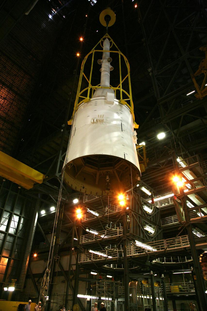 CAPE CANAVERAL, Fla. – In the Vehicle Assembly Building's High Bay 4, assembly of the Ares I-X rocket nears completion. The yellow framework, nicknamed the "birdcage," lifts Super Stack 5. The stack will be positioned on top of the segments already in place on the mobile launcher platform in High Bay 3, completing assembly of the 327-foot-tall rocket. Five super stacks make up the rocket's upper stage that is integrated with the four-segment solid rocket booster first stage. Ares I-X is the test vehicle for the Ares I, which is part of the Constellation Program to return men to the moon and beyond. The Ares I-X flight test is targeted for Oct. 31, pending formal NASA Headquarters approval. Photo credit: NASA/Dimitri Gerondidakis