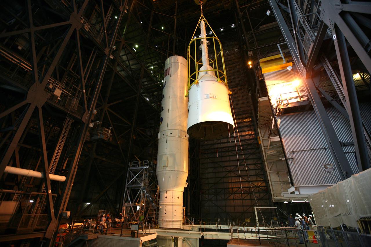 CAPE CANAVERAL, Fla. – In the Vehicle Assembly Building's High Bay 3, assembly of the Ares I-X rocket nears completion. The yellow framework, nicknamed the "birdcage," lifts Super Stack 5 to the top of the segments already in place on the mobile launcher platform. Once in place, assembly of the rocket will be complete. The 327-foot-tall rocket is one of the largest processed in the bay, rivaling the height of the Apollo Program's 364-foot-tall Saturn V. Five super stacks make up the rocket's upper stage that is integrated with the four-segment solid rocket booster first stage. Ares I-X is the test vehicle for the Ares I, which is part of the Constellation Program to return men to the moon and beyond. The Ares I-X flight test is targeted for Oct. 31, pending formal NASA Headquarters approval. Photo credit: NASA/Dimitri Gerondidakis