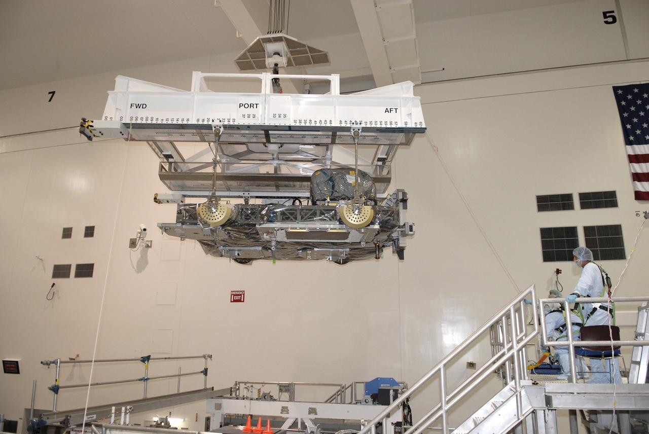 CAPE CANAVERAL, Fla. – In NASA Kennedy Space Center's Space Station Processing Facility, an overhead crane moves the Express Logistics Carrier, or ELC, to a rotation stand. The carrier is part of the STS-129 payload on space shuttle Atlantis, which will deliver to the International Space Station two spare gyroscopes, two nitrogen tank assemblies, two pump modules, an ammonia tank assembly and a spare latching end effector for the station's robotic arm. STS-129 is targeted to launch Nov. 12.  Photo credit: NASA/Kim Shiflett