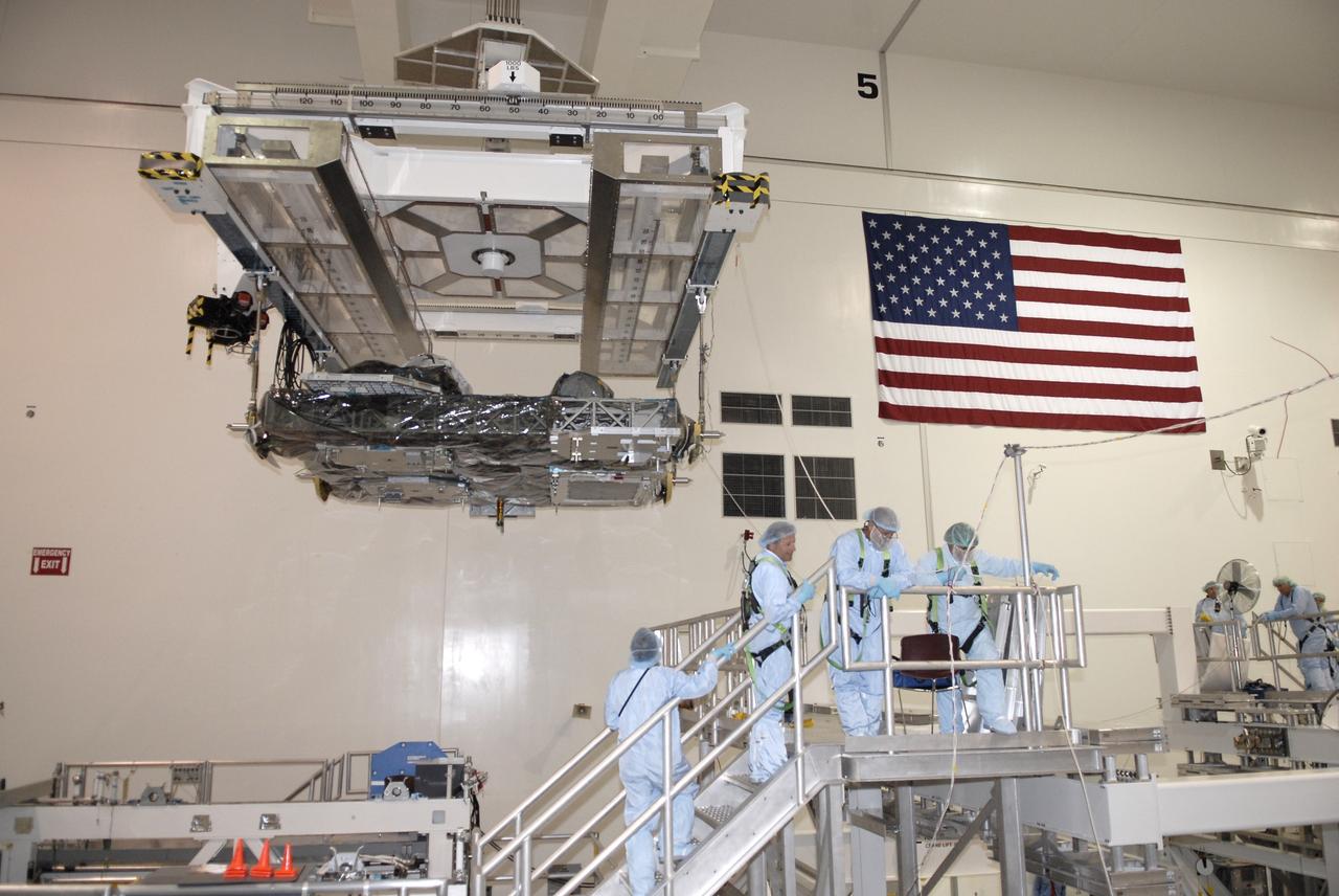 CAPE CANAVERAL, Fla. – In NASA Kennedy Space Center's Space Station Processing Facility, an overhead crane moves the Express Logistics Carrier, or ELC, to a rotation stand.  The carrier is part of the STS-129 payload on space shuttle Atlantis, which will deliver to the International Space Station two spare gyroscopes, two nitrogen tank assemblies, two pump modules, an ammonia tank assembly and a spare latching end effector for the station's robotic arm. STS-129 is targeted to launch Nov. 12.  Photo credit: NASA/Kim Shiflett