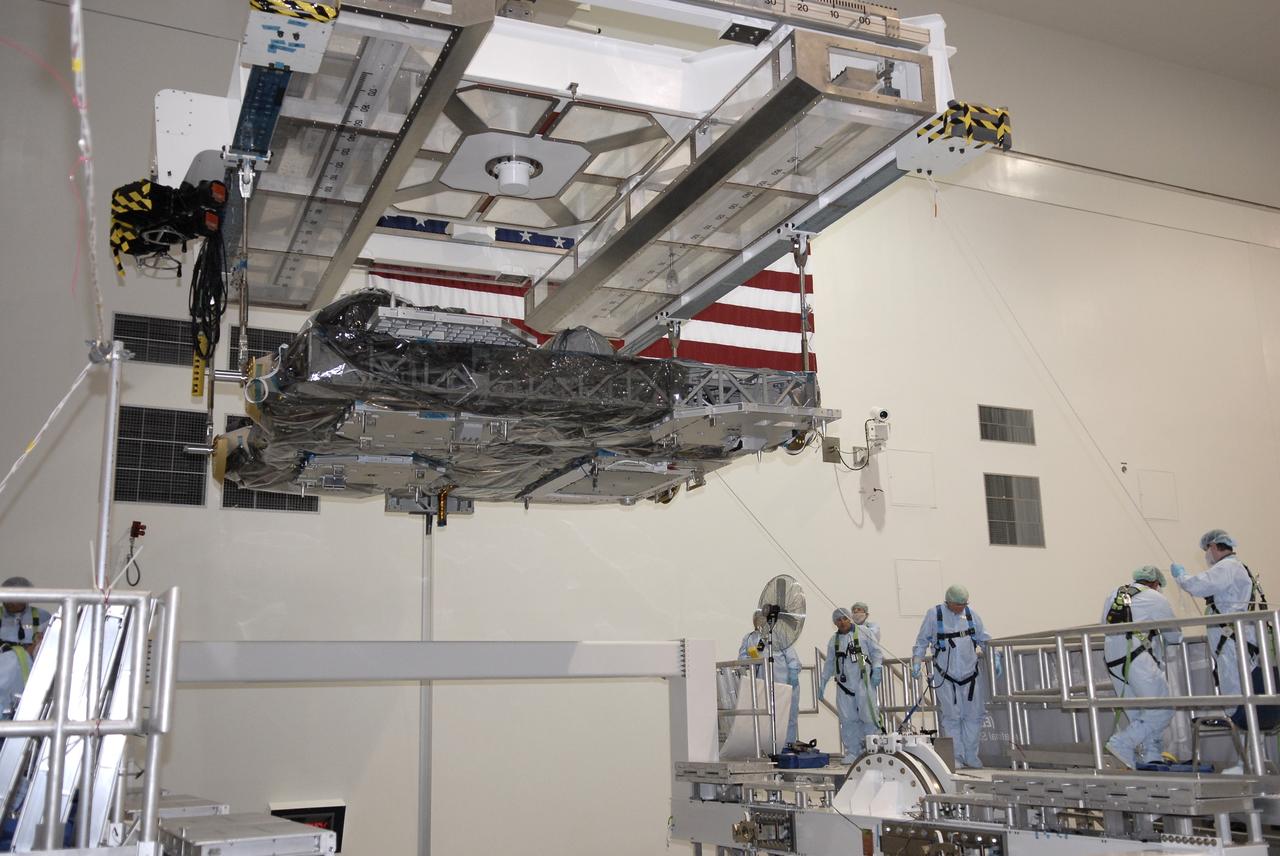 CAPE CANAVERAL, Fla. – In NASA Kennedy Space Center's Space Station Processing Facility, an overhead crane moves the Express Logistics Carrier, or ELC, to a rotation stand.  The carrier is part of the STS-129 payload on space shuttle Atlantis, which will deliver to the International Space Station two spare gyroscopes, two nitrogen tank assemblies, two pump modules, an ammonia tank assembly and a spare latching end effector for the station's robotic arm. STS-129 is targeted to launch Nov. 12.  Photo credit: NASA/Kim Shiflett
