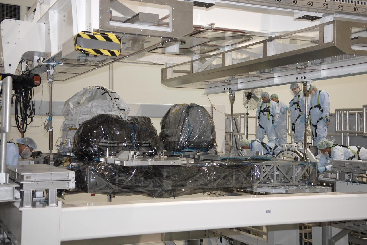 CAPE CANAVERAL, Fla. –In NASA Kennedy Space Center's Space Station Processing Facility, an overhead crane places the Express Logistics Carrier, or ELC, onto a rotation stand. The carrier is part of the STS-129 payload on space shuttle Atlantis, which will deliver to the International Space Station two spare gyroscopes, two nitrogen tank assemblies, two pump modules, an ammonia tank assembly and a spare latching end effector for the station's robotic arm. STS-129 is targeted to launch Nov. 12. Photo credit: NASA/Kim Shiflett