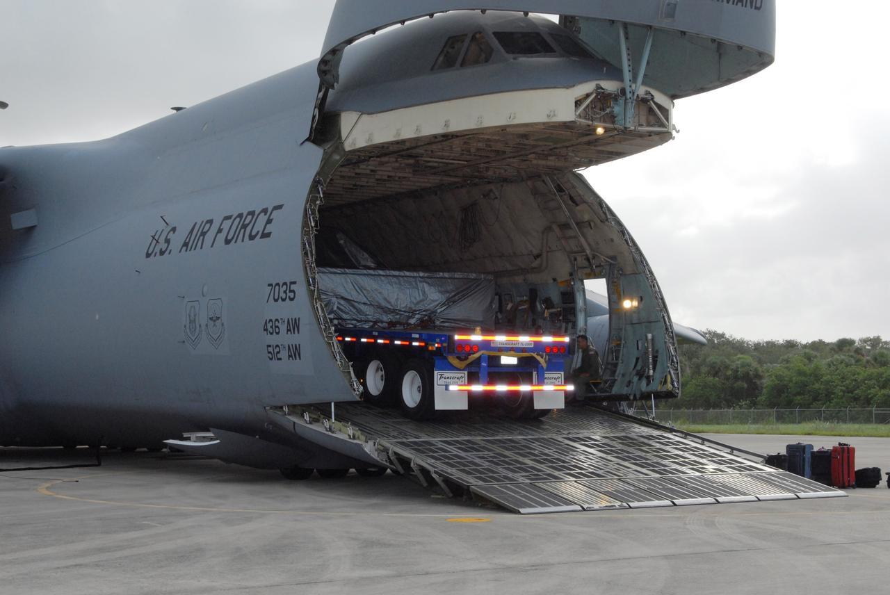CAPE CANAVERAL, Fla. – On NASA Kennedy Space Center's Shuttle Landing Facility, the Express Logistics Carrier 4, or ELC4, is moved out of the U.S. Air Force C-5. The ELC4 is part of the payload for the STS-133 mission. Space shuttle Endeavour will deliver the ELC4 and ELC3 with critical spare components to the International Space Station on the mission.  Endeavour's launch is targeted for late July in 2010.  Photo credit: NASA/Amanda Diller