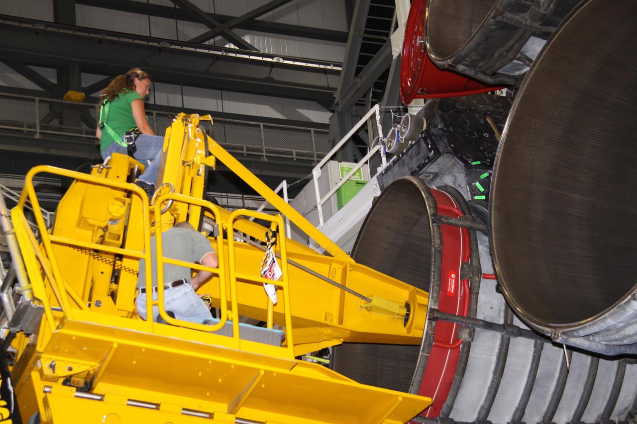 CAPE CANAVERAL, Fla. – In Orbiter Processing Bay 2 at NASA's Kennedy Space Center in Florida, technicians using a Hyster forklift prepare to remove main engine no. 2 on space shuttle Endeavour.  Engine removal is part of the post-landing processing. Endeavour returned from the STS-127 mission July 31. Endeavour's next mission is STS-130 targeted for February 2010.  Endeavour will deliver to the International Space Station the Tranquility pressurized module that will provide room for many of the station's life support systems.  Photo credit: NASA/Jack Pfaller