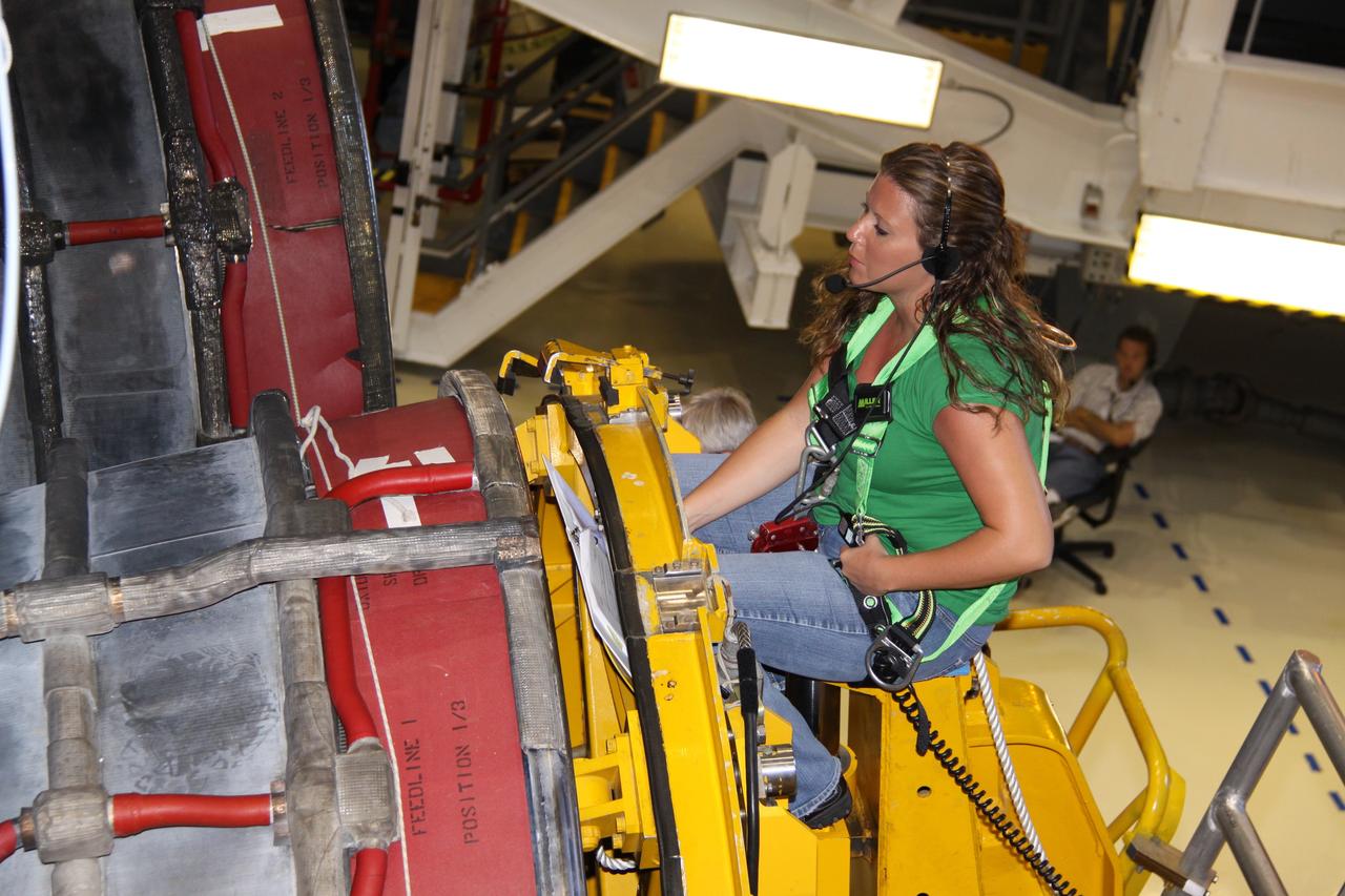 CAPE CANAVERAL, Fla. – In Orbiter Processing Bay 2 at NASA's Kennedy Space Center in Florida, a technician maneuvers a Hyster forklift into main engine no. 2 on space shuttle Endeavour to remove it. Engine removal is part of the post-landing processing. Endeavour returned from the STS-127 mission July 31. Endeavour's next mission is STS-130 targeted for February 2010. Endeavour will deliver to the International Space Station the Tranquility pressurized module that will provide room for many of the station's life support systems. Photo credit: NASA/Jack Pfaller