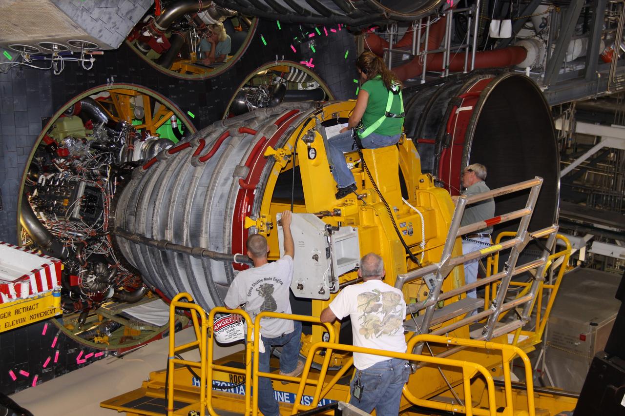 CAPE CANAVERAL, Fla. – In Orbiter Processing Bay 2 at NASA's Kennedy Space Center in Florida, technicians using a Hyster forklift remove main engine no. 2 from space shuttle Endeavour. Engine removal is part of the post-landing processing. Endeavour returned from the STS-127 mission July 31. Endeavour's next mission is STS-130 targeted for February 2010. Endeavour will deliver to the International Space Station the Tranquility pressurized module that will provide room for many of the station's life support systems. Photo credit: NASA/Jack Pfaller