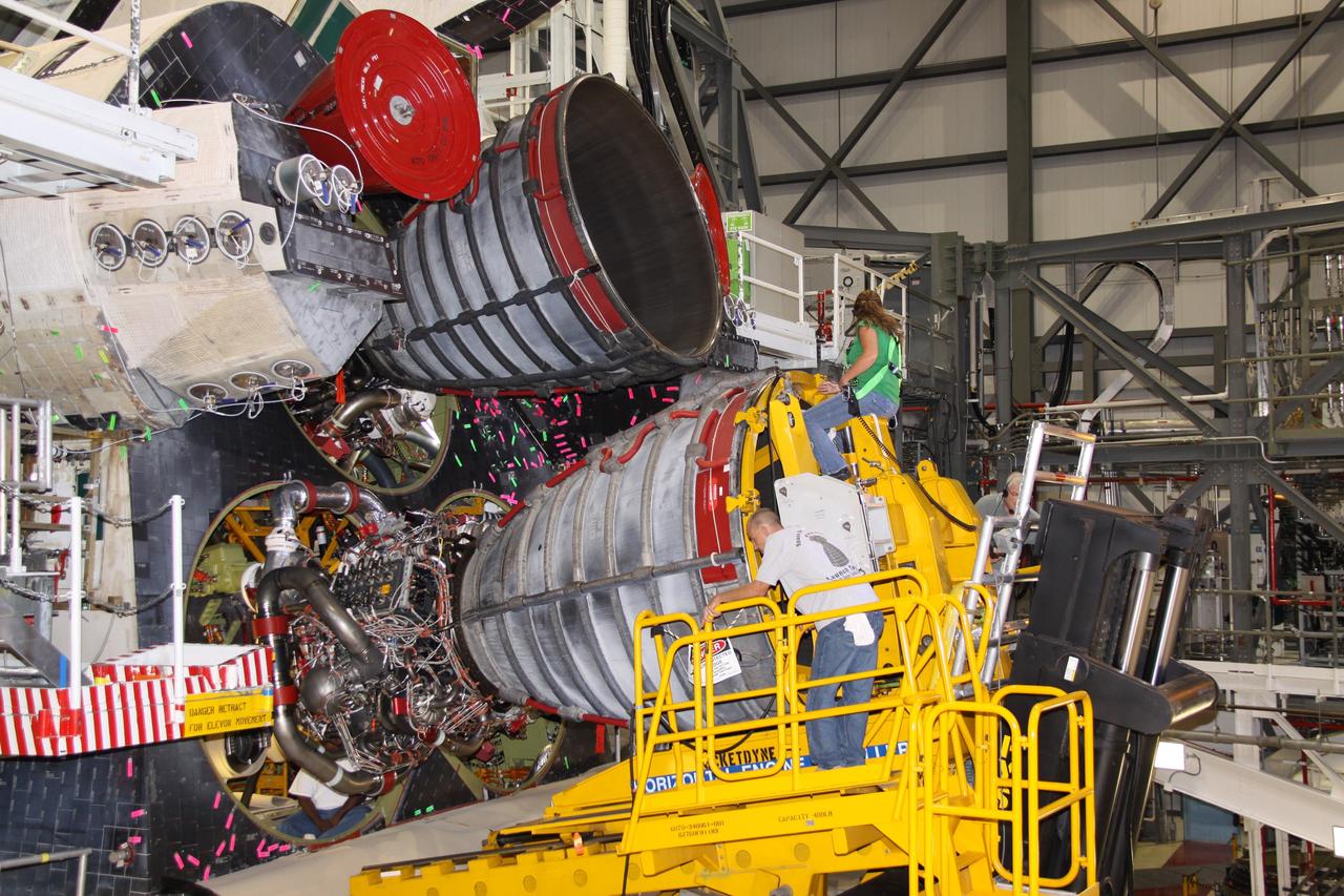 CAPE CANAVERAL, Fla. – In Orbiter Processing Bay 2 at NASA's Kennedy Space Center in Florida, technicians using a Hyster forklift remove main engine no. 2 from space shuttle Endeavour. Engine removal is part of the post-landing processing. Endeavour returned from the STS-127 mission July 31. Endeavour's next mission is STS-130 targeted for February 2010. Endeavour will deliver to the International Space Station the Tranquility pressurized module that will provide room for many of the station's life support systems. Photo credit: NASA/Jack Pfaller