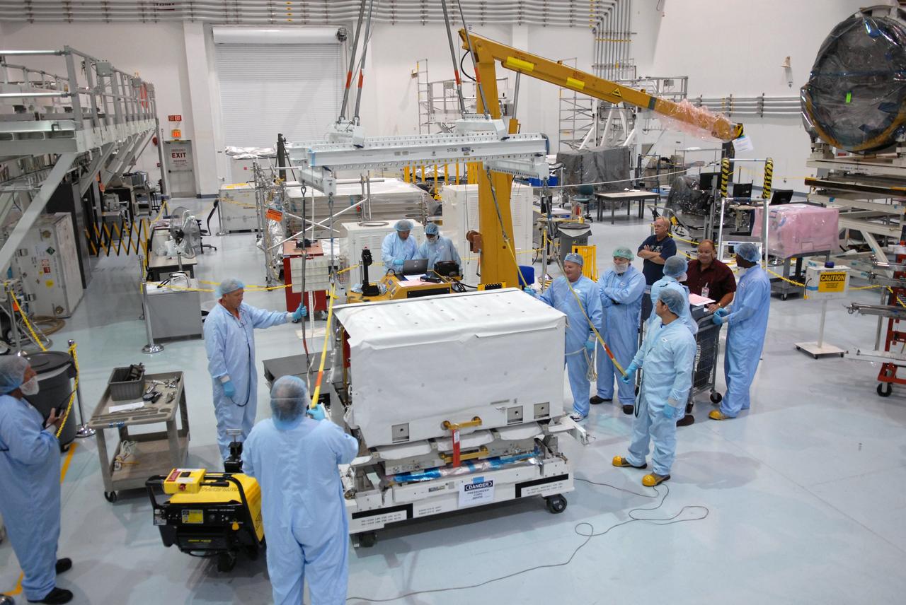 CAPE CANAVERAL, Fla. – In the Space Station Processing Facility at NASA's Kennedy Space Center in Florida, technicians prepare to lift the nitrogen tank assembly to move it to the Express Logistics Carrier 1, or ELC-1. The carrier is part of the STS-129 payload on space shuttle Atlantis, which will deliver to the International Space Station two spare gyroscopes, two nitrogen tank assemblies, two pump modules, an ammonia tank assembly and a spare latching end effector for the station's robotic arm. STS-129 is targeted to launch Nov. 12. Photo credit: NASA/Jim Grossmann