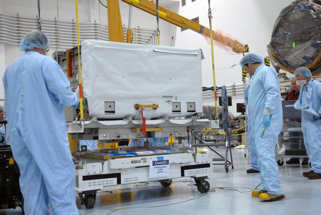 CAPE CANAVERAL, Fla. – In the Space Station Processing Facility at NASA's Kennedy Space Center in Florida, technicians watch closely as an overhead crane lifts the nitrogen tank assembly to move it to the Express Logistics Carrier 1, or ELC-1. The carrier is part of the STS-129 payload on space shuttle Atlantis, which will deliver to the International Space Station two spare gyroscopes, two nitrogen tank assemblies, two pump modules, an ammonia tank assembly and a spare latching end effector for the station's robotic arm. STS-129 is targeted to launch Nov. 12. Photo credit: NASA/Jim Grossmann