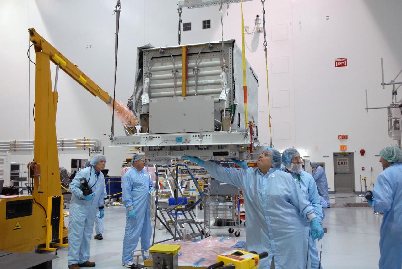 CAPE CANAVERAL, Fla. – In the Space Station Processing Facility at NASA's Kennedy Space Center in Florida, technicians check the nitrogen tank assembly closely as an overhead crane lifts and moves it to the Express Logistics Carrier 1, or ELC-1. The carrier is part of the STS-129 payload on space shuttle Atlantis, which will deliver to the International Space Station two spare gyroscopes, two nitrogen tank assemblies, two pump modules, an ammonia tank assembly and a spare latching end effector for the station's robotic arm. STS-129 is targeted to launch Nov. 12. Photo credit: NASA/Jim Grossmann