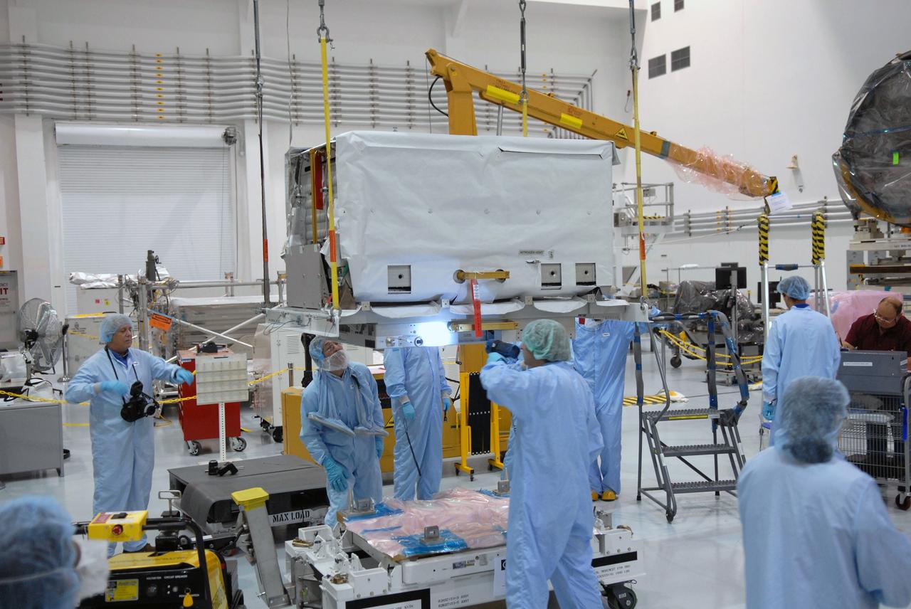 CAPE CANAVERAL, Fla. – In the Space Station Processing Facility at NASA's Kennedy Space Center in Florida, technicians check the nitrogen tank assembly closely as an overhead crane lifts and moves it to the Express Logistics Carrier 1, or ELC-1. The carrier is part of the STS-129 payload on space shuttle Atlantis, which will deliver to the International Space Station two spare gyroscopes, two nitrogen tank assemblies, two pump modules, an ammonia tank assembly and a spare latching end effector for the station's robotic arm. STS-129 is targeted to launch Nov. 12. Photo credit: NASA/Jim Grossmann