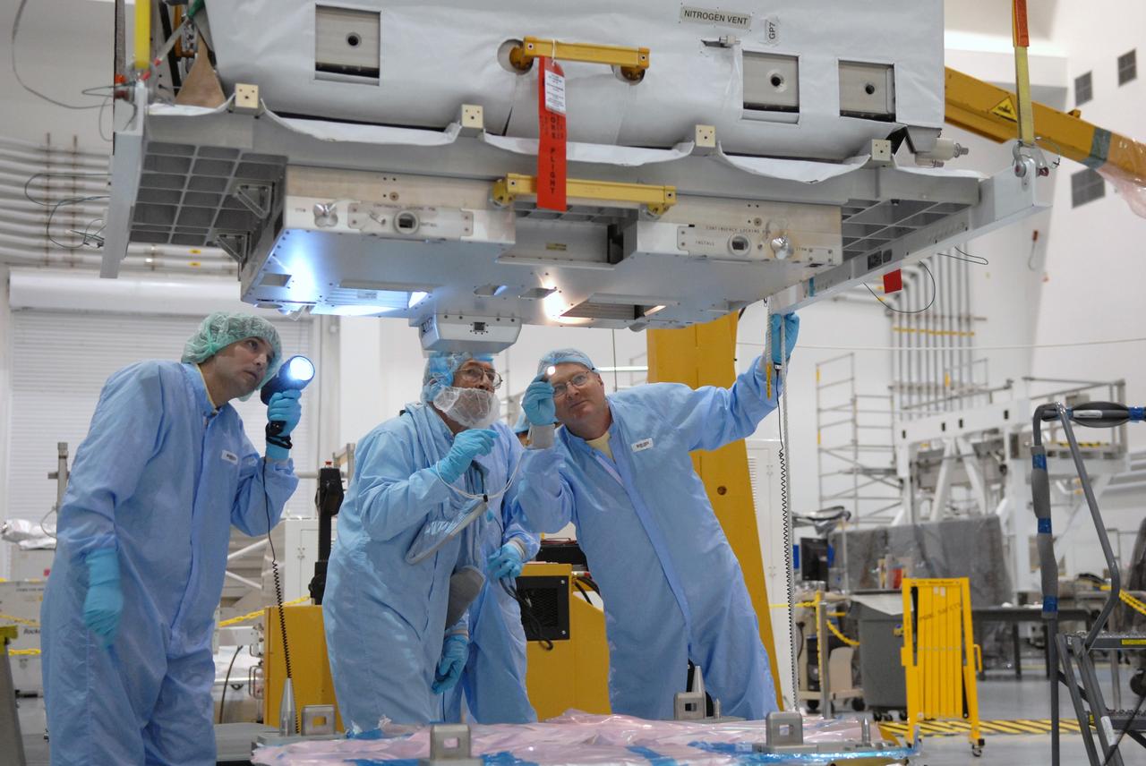 CAPE CANAVERAL, Fla. – In the Space Station Processing Facility at NASA's Kennedy Space Center in Florida, technicians check the nitrogen tank assembly closely as an overhead crane lifts and moves it to the Express Logistics Carrier 1, or ELC-1. The carrier is part of the STS-129 payload on space shuttle Atlantis, which will deliver to the International Space Station two spare gyroscopes, two nitrogen tank assemblies, two pump modules, an ammonia tank assembly and a spare latching end effector for the station's robotic arm. STS-129 is targeted to launch Nov. 12. Photo credit: NASA/Jim Grossmann