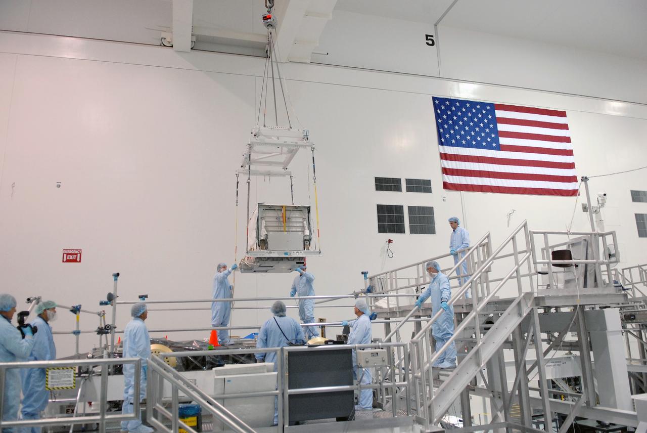 CAPE CANAVERAL, Fla. – In the Space Station Processing Facility at NASA's Kennedy Space Center in Florida, the nitrogen tank assembly is lowered toward the Express Logistics Carrier 1, or ELC-1. The carrier is part of the STS-129 payload on space shuttle Atlantis, which will deliver to the International Space Station two spare gyroscopes, two nitrogen tank assemblies, two pump modules, an ammonia tank assembly and a spare latching end effector for the station's robotic arm. STS-129 is targeted to launch Nov. 12. Photo credit: NASA/Jim Grossmann