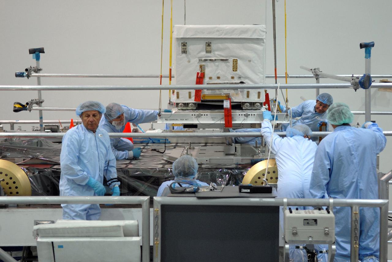 CAPE CANAVERAL, Fla. – In the Space Station Processing Facility at NASA's Kennedy Space Center in Florida, technicians check closely as the nitrogen tank assembly is lowered closer to the Express Logistics Carrier 1, or ELC-1. The carrier is part of the STS-129 payload on space shuttle Atlantis, which will deliver to the International Space Station two spare gyroscopes, two nitrogen tank assemblies, two pump modules, an ammonia tank assembly and a spare latching end effector for the station's robotic arm. STS-129 is targeted to launch Nov. 12. Photo credit: NASA/Jim Grossmann